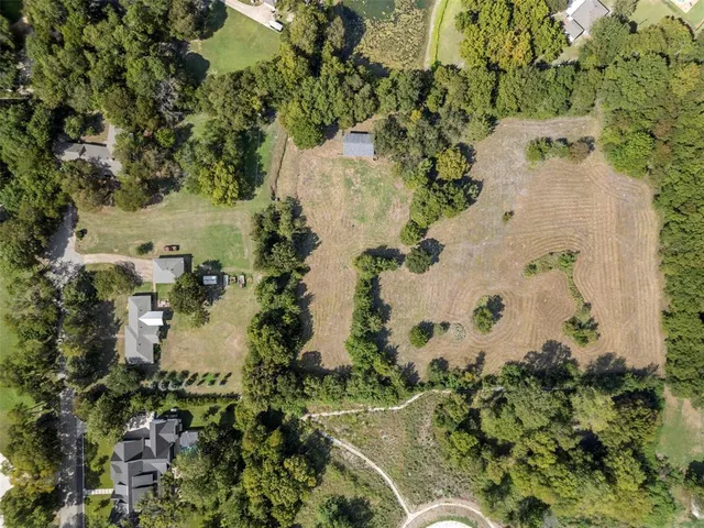 an aerial view of residential house with green space