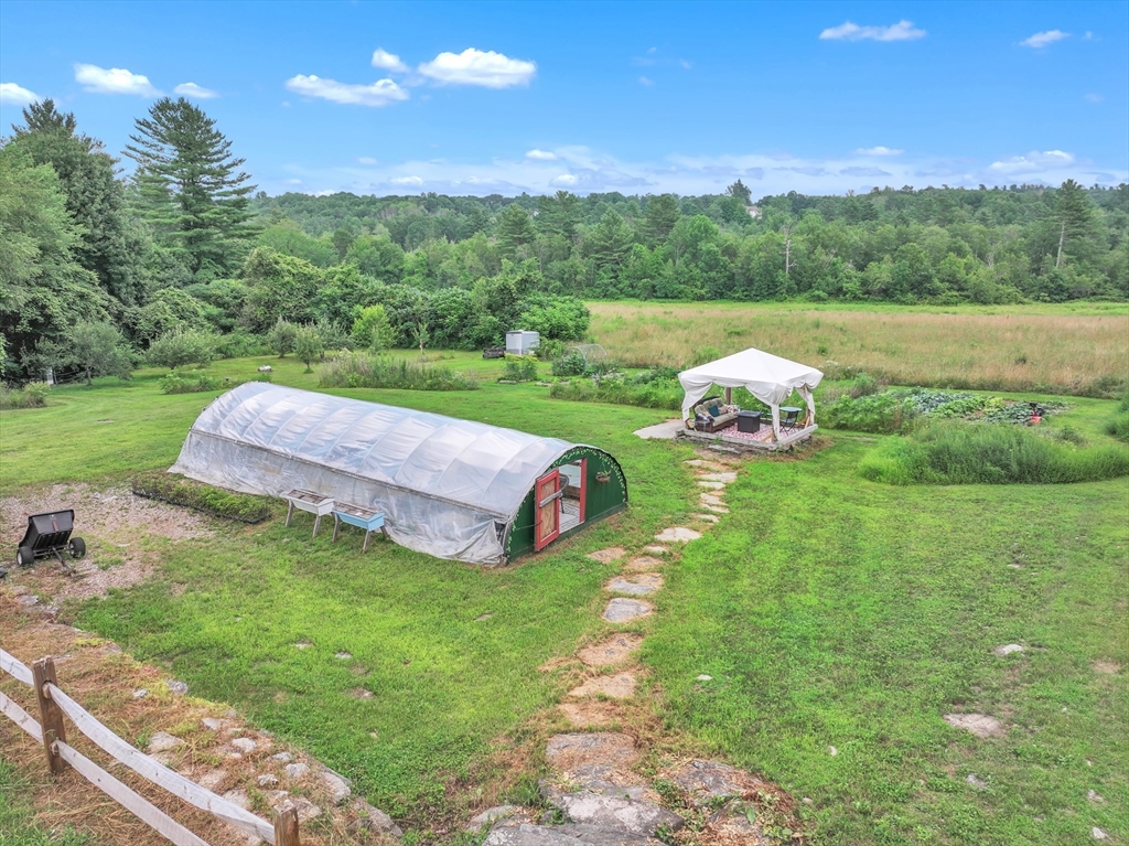 665 Thresher Road Hardwick, MA 01037 - Photo 12 of 41 a view of a table and chairs in the garden