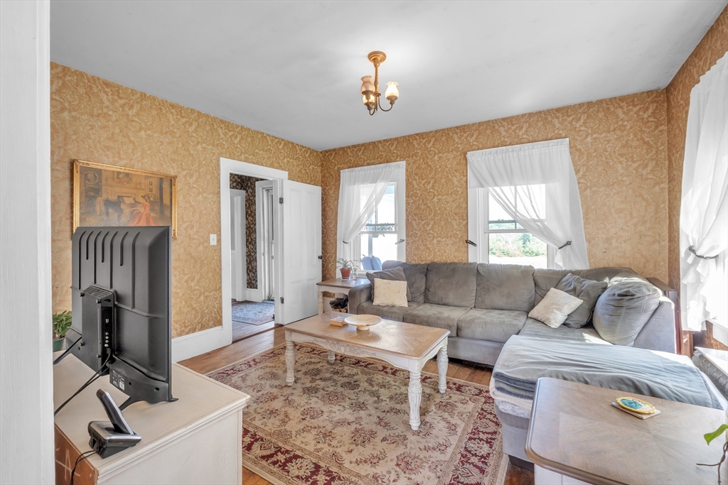 665 Thresher Road Hardwick, MA 01037 - Photo 17 of 41 a living room with furniture a flat screen tv and a window