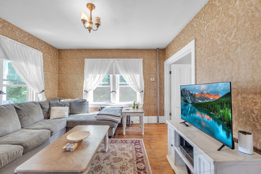 665 Thresher Road Hardwick, MA 01037 - Photo 18 of 41 a living room with furniture and a flat screen tv
