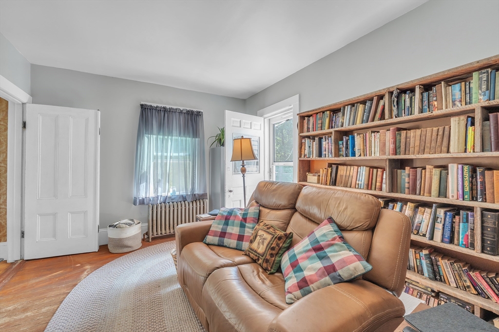 665 Thresher Road Hardwick, MA 01037 - Photo 20 of 41 a living room with furniture book shelf and a window