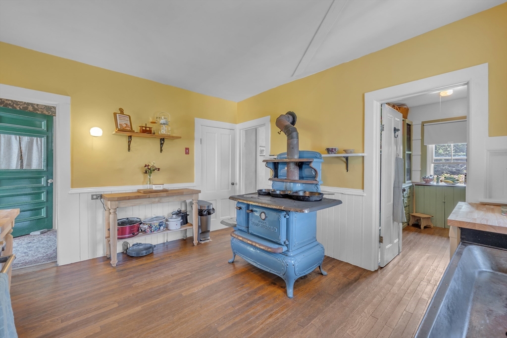 665 Thresher Road Hardwick, MA 01037 - Photo 25 of 41 a kitchen with stainless steel appliances a stove and wooden floor