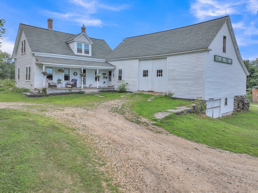 665 Thresher Road Hardwick, MA 01037 - Photo 4 of 41 a front view of house with yard and outdoor seating