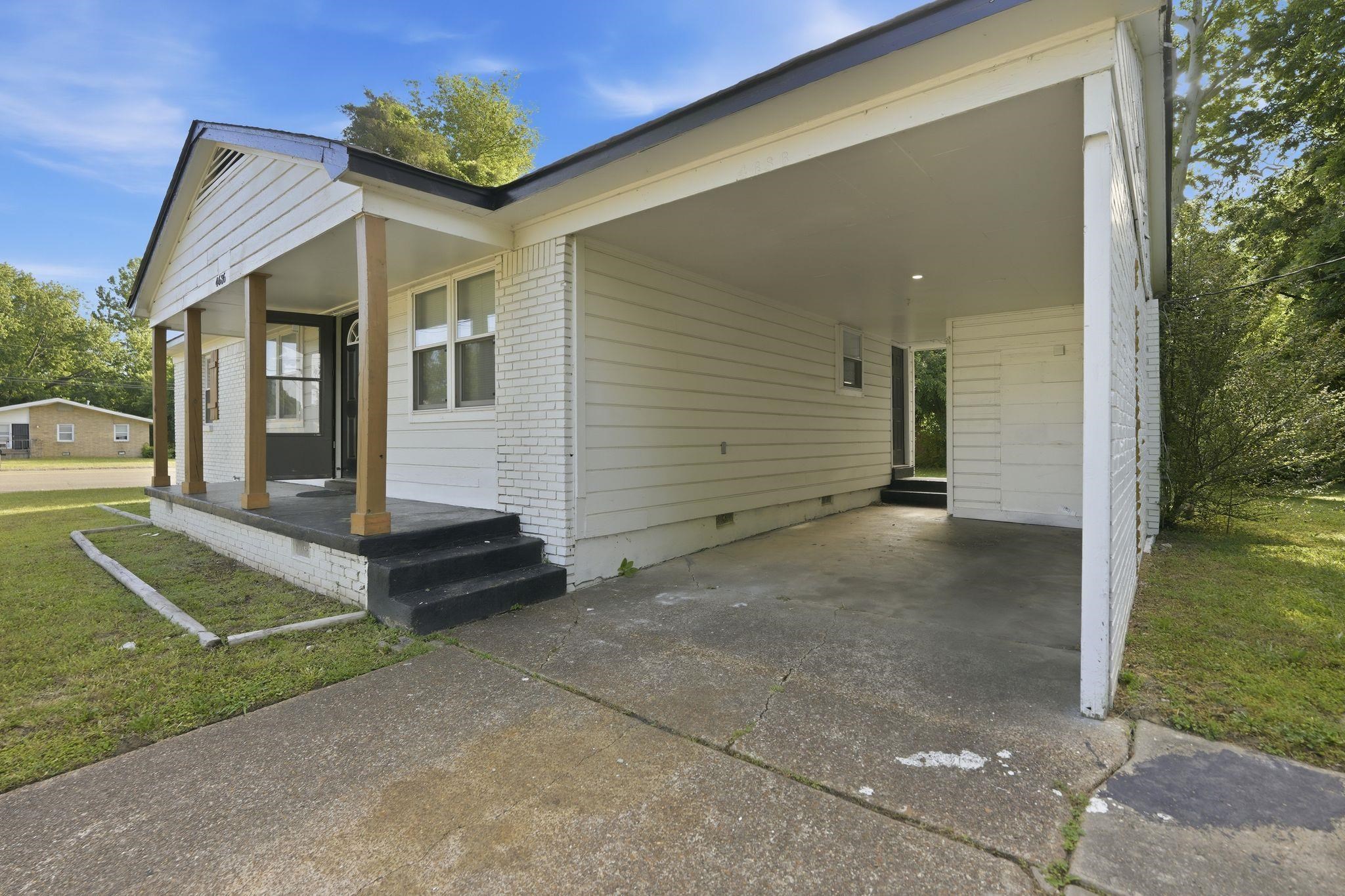 4686 Gill Road Memphis, TN 38109 - Photo 3 of 32 White exterior siding with brick accents and a covered front porch featuring wooden support columns
