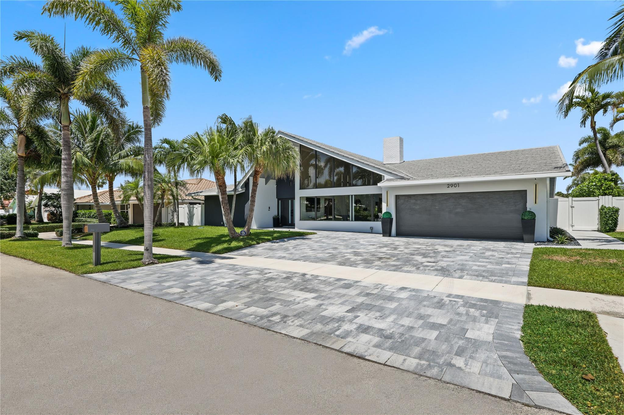 2901 Northeast 46th Street Lighthouse Point, FL 33064 - Photo 1 of 79 a front view of house with yard and green space