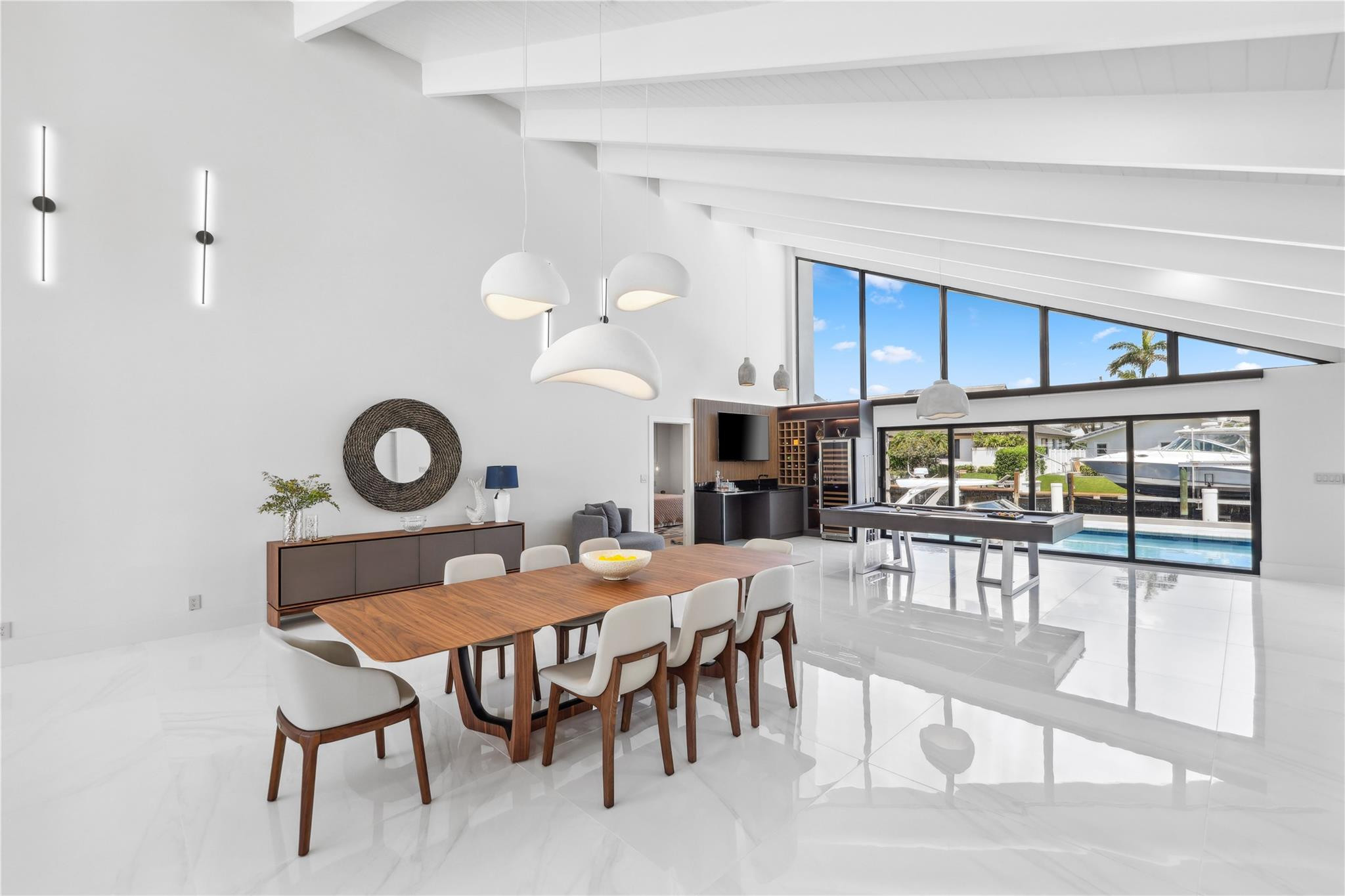 2901 Northeast 46th Street Lighthouse Point, FL 33064 - Photo 12 of 79 a view of a dining room and kitchen with furniture and a clock
