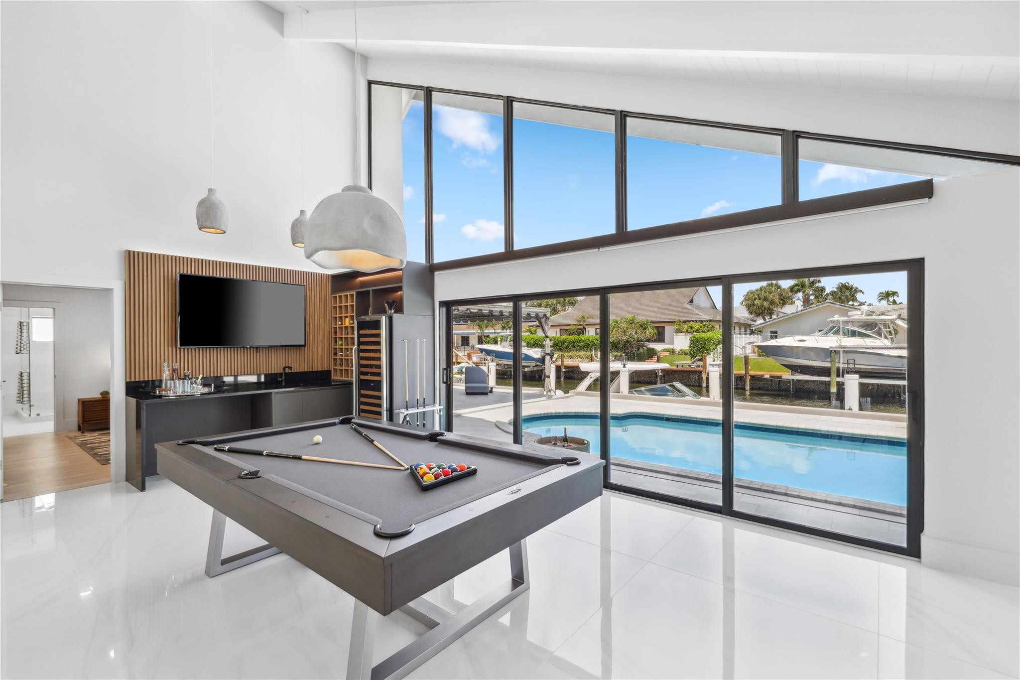 2901 Northeast 46th Street Lighthouse Point, FL 33064 - Photo 16 of 79 a living room with projector and a flat screen tv