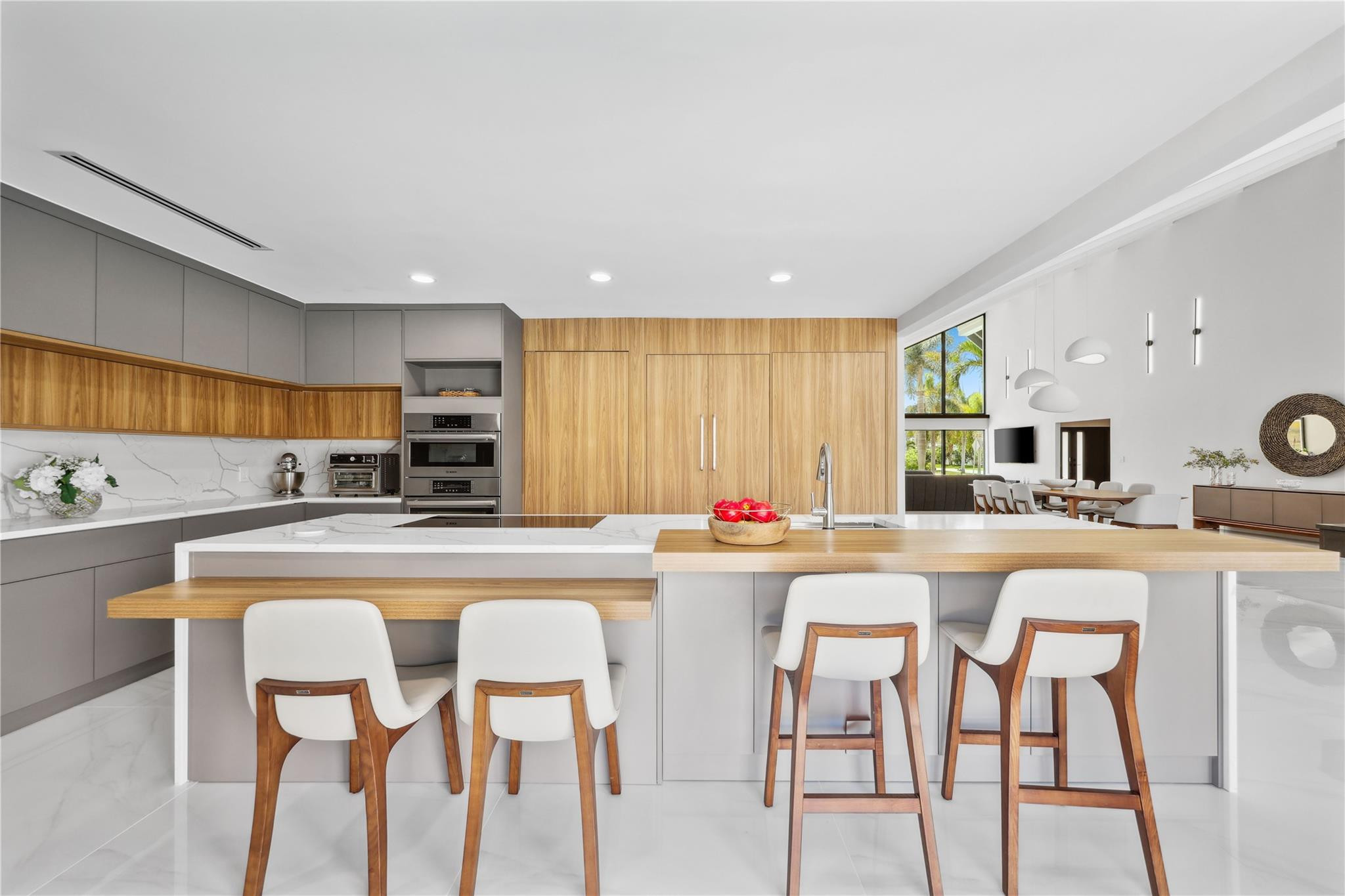 2901 Northeast 46th Street Lighthouse Point, FL 33064 - Photo 23 of 79 a kitchen with stainless steel appliances granite countertop a table and chairs in it