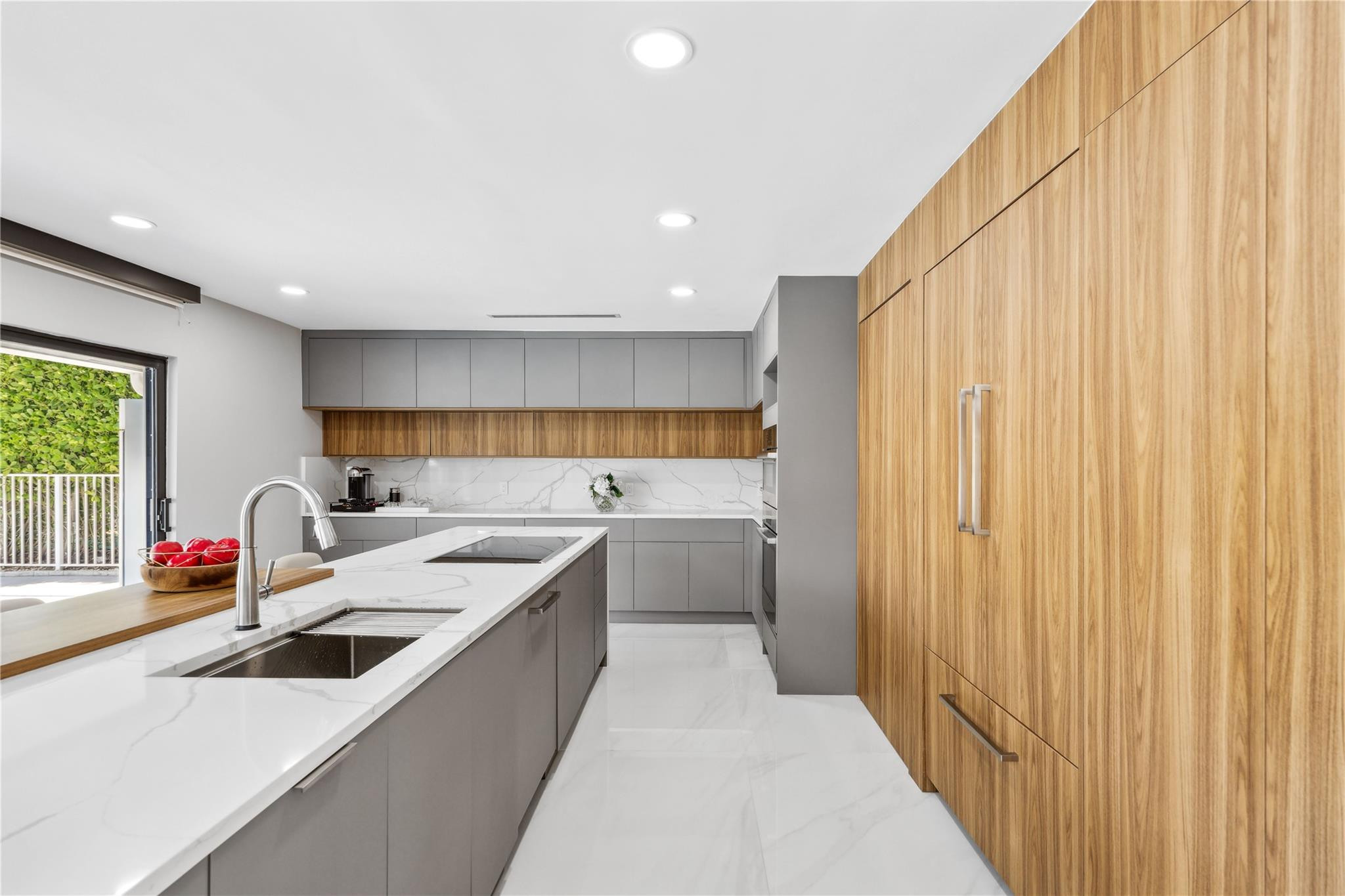 2901 Northeast 46th Street Lighthouse Point, FL 33064 - Photo 27 of 79 a kitchen that has a lot of cabinets in it and wooden floor