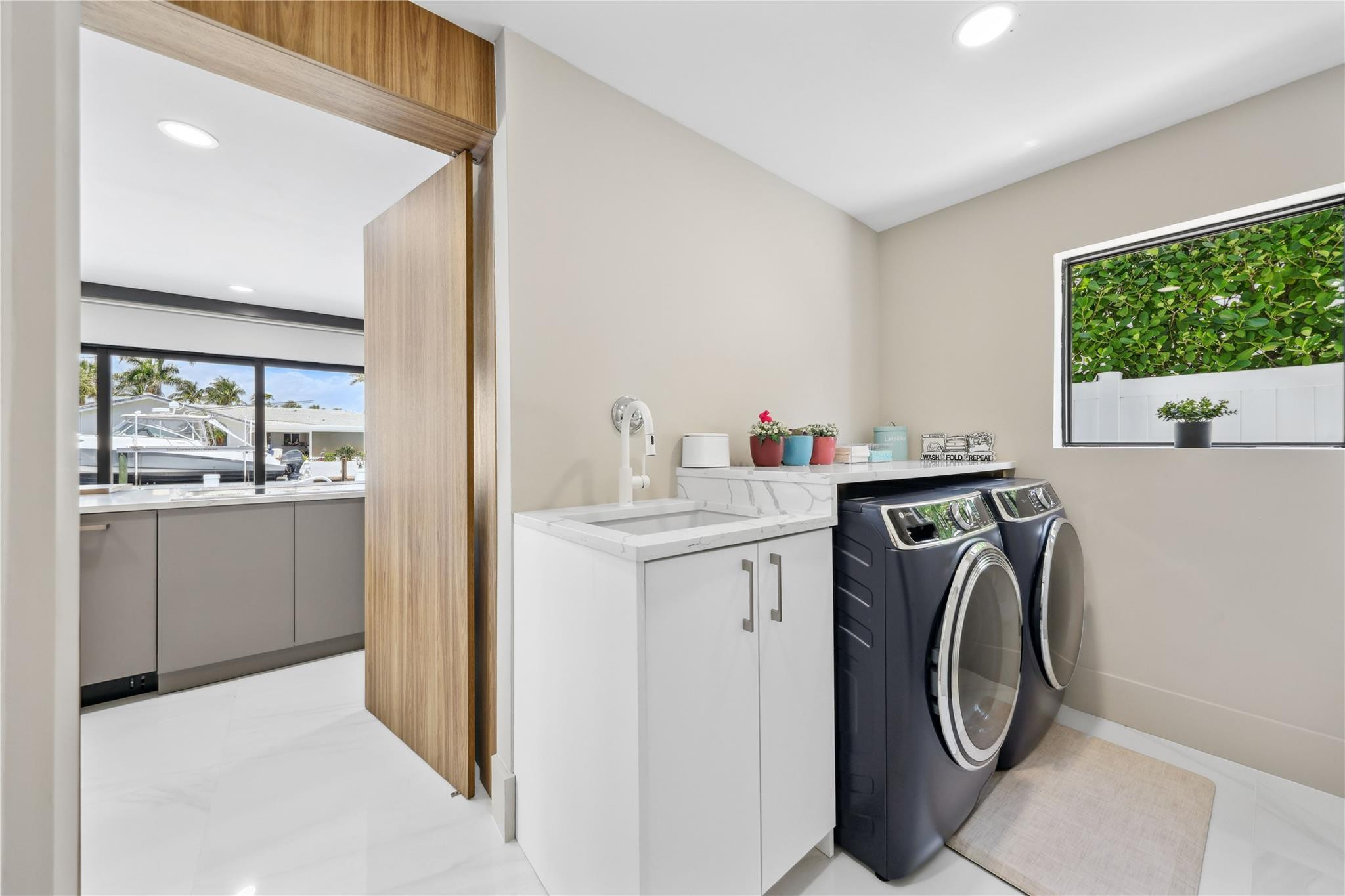 2901 Northeast 46th Street Lighthouse Point, FL 33064 - Photo 30 of 79 a utility room with sink dryer and washer