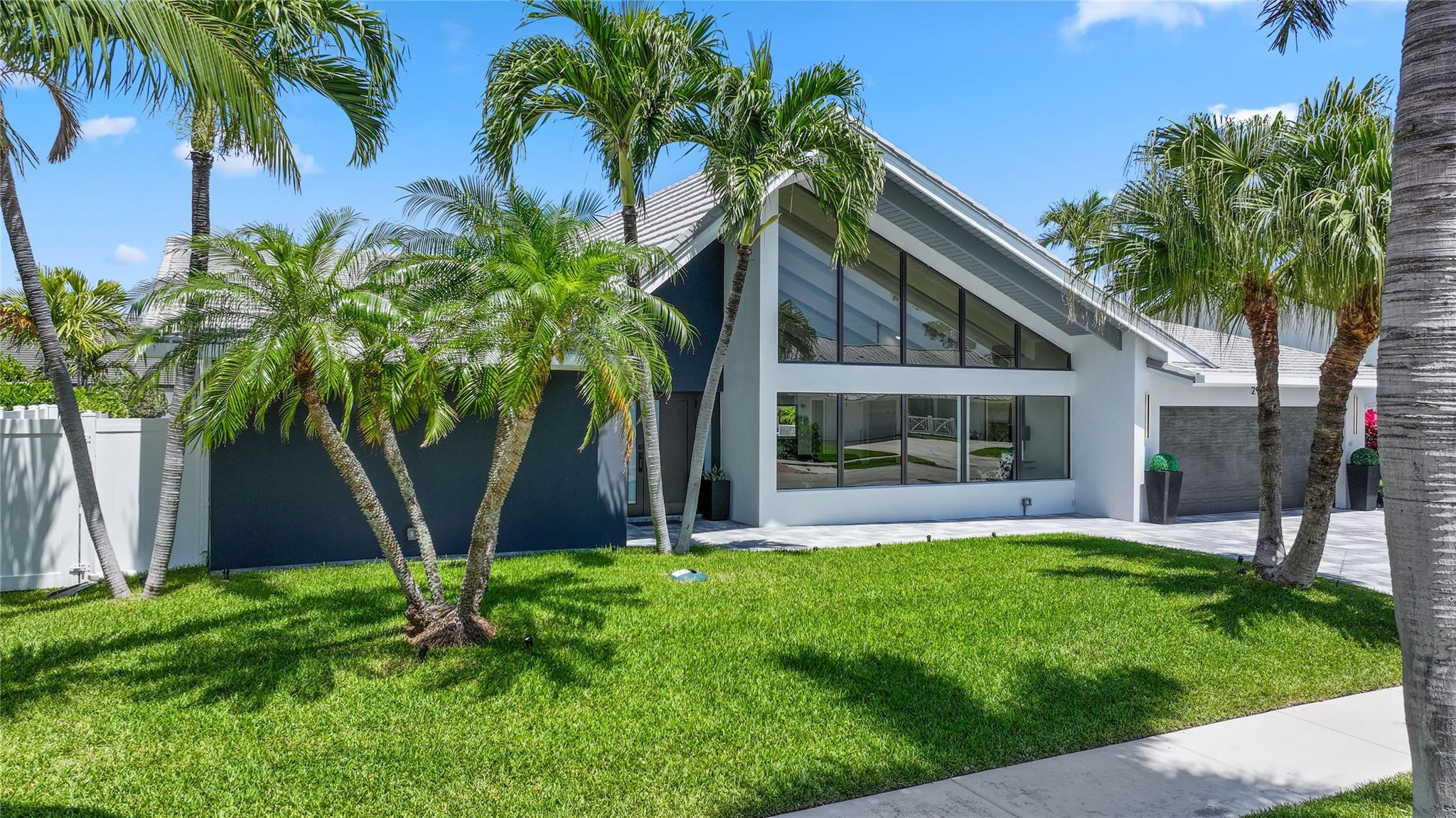 2901 Northeast 46th Street Lighthouse Point, FL 33064 - Photo 3 of 79 a front view of house with yard and green space