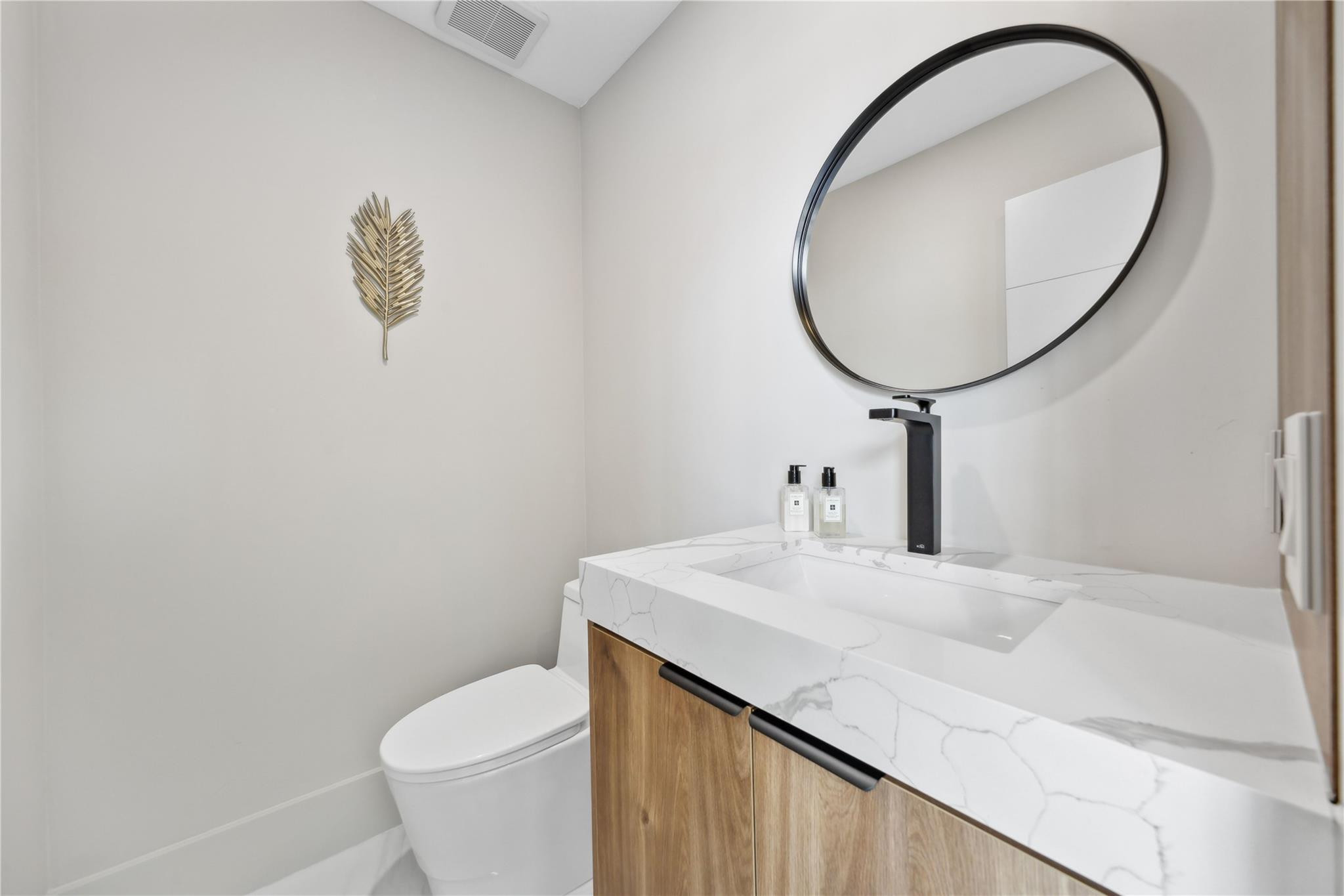 2901 Northeast 46th Street Lighthouse Point, FL 33064 - Photo 31 of 79 a bathroom with a sink a toilet and a mirror