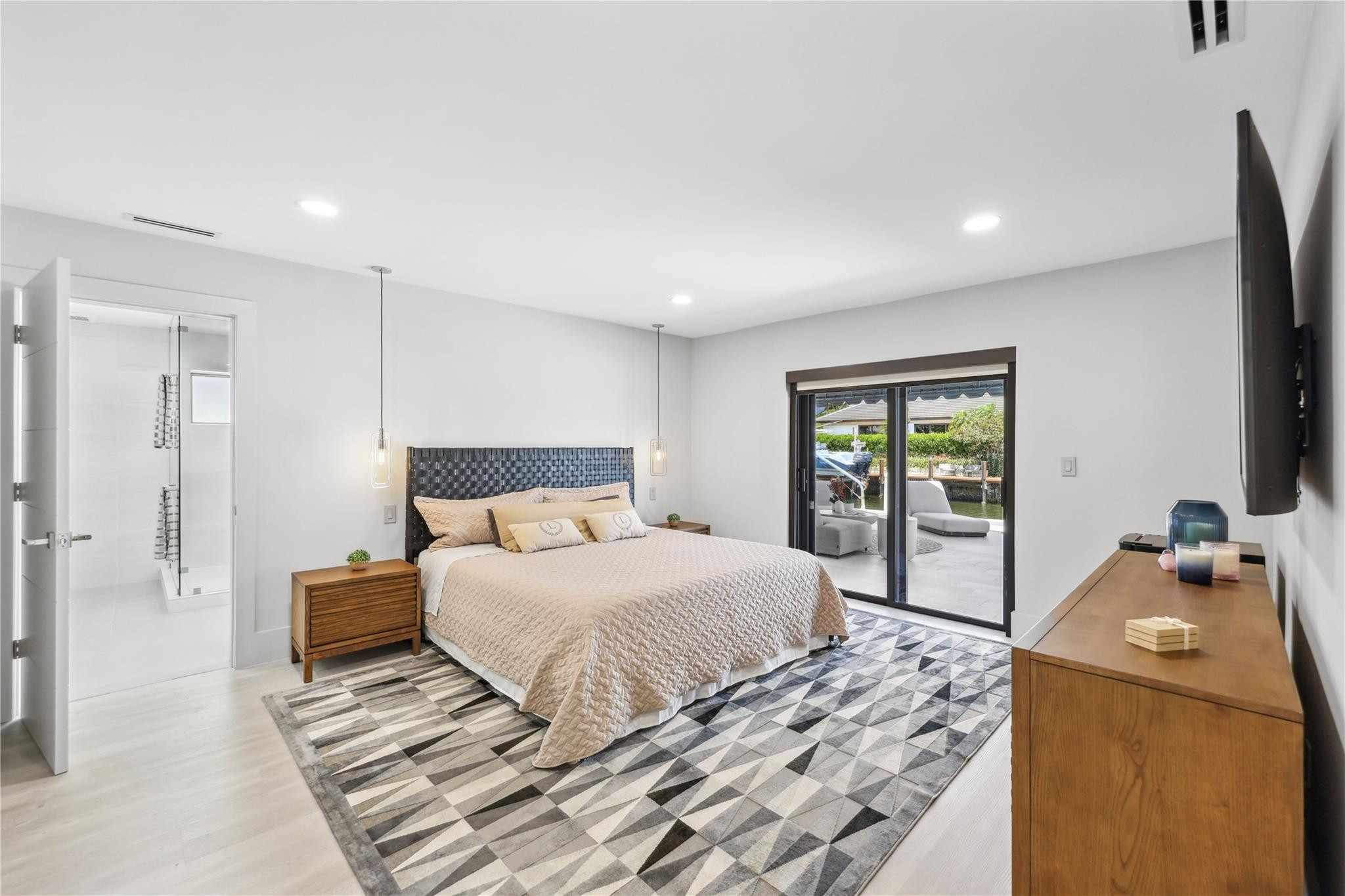 2901 Northeast 46th Street Lighthouse Point, FL 33064 - Photo 35 of 79 a bedroom with a large bed and a flat tv screen