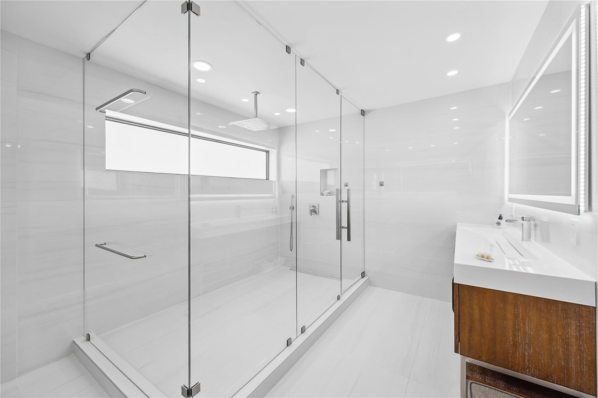 2901 Northeast 46th Street Lighthouse Point, FL 33064 - Photo 39 of 79 a bathroom with a glass shower door and a sink