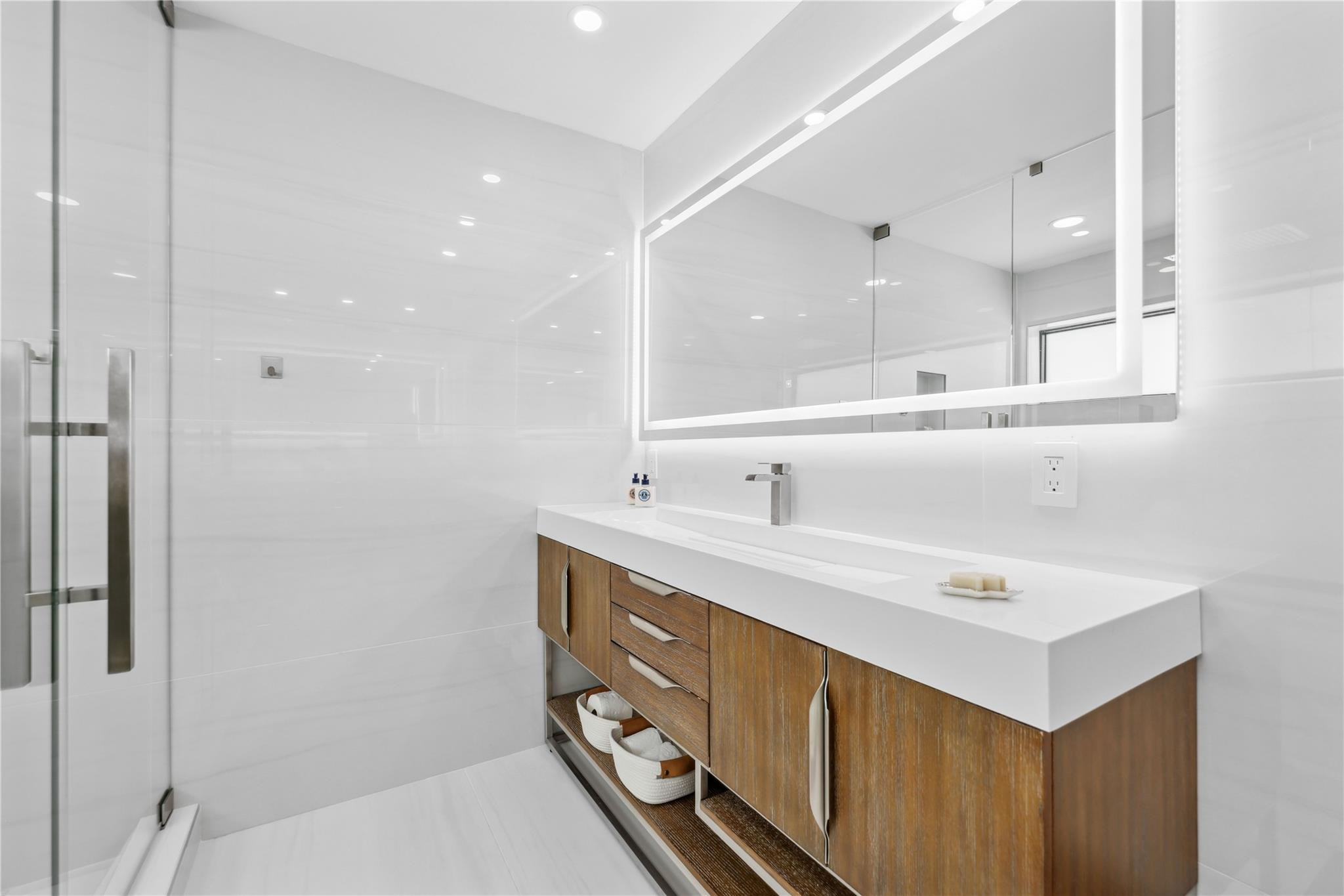 2901 Northeast 46th Street Lighthouse Point, FL 33064 - Photo 40 of 79 a bathroom with a sink double vanity and a mirror