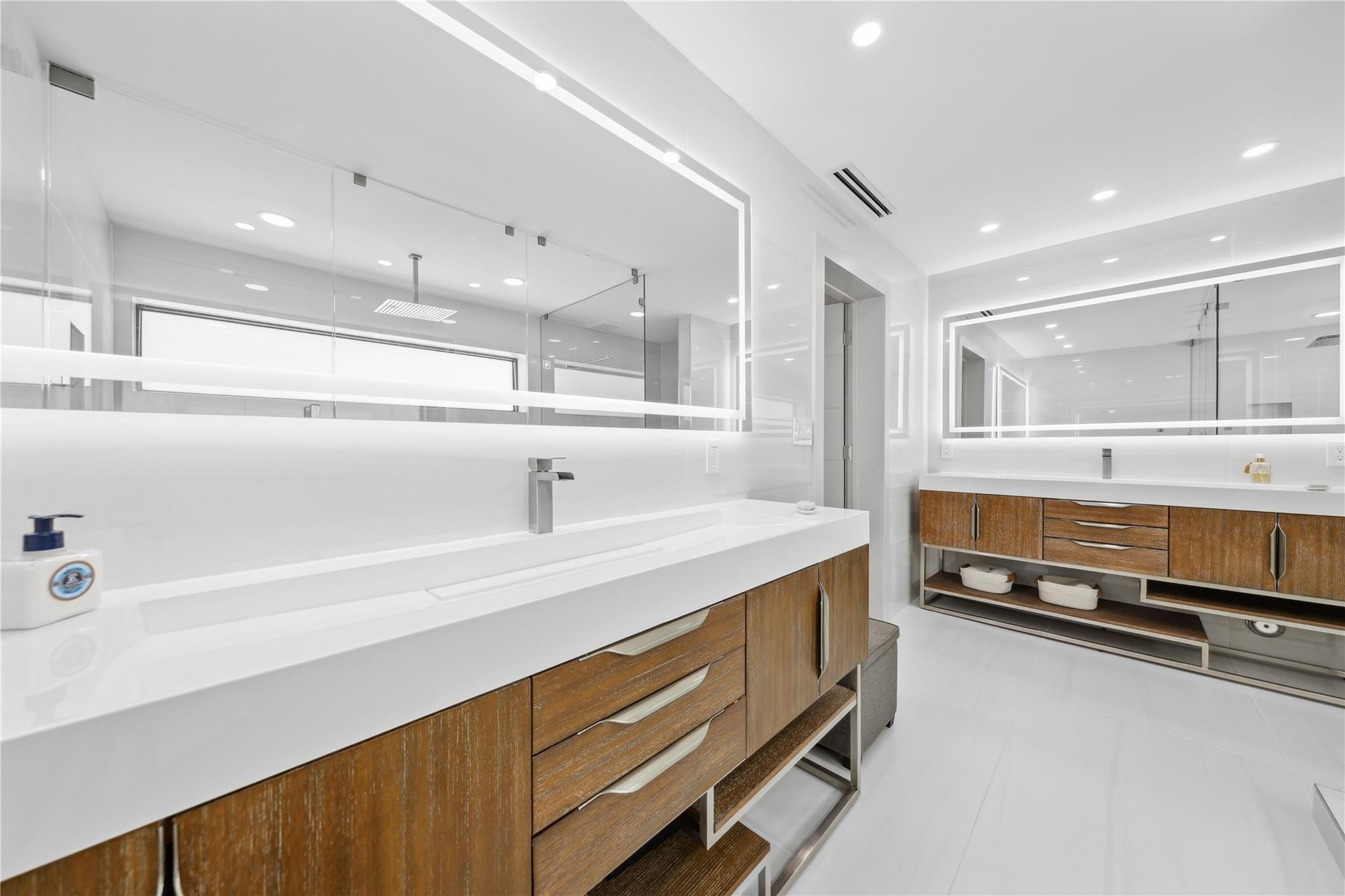 2901 Northeast 46th Street Lighthouse Point, FL 33064 - Photo 42 of 79 a spacious bathroom with a double vanity sink and a mirror