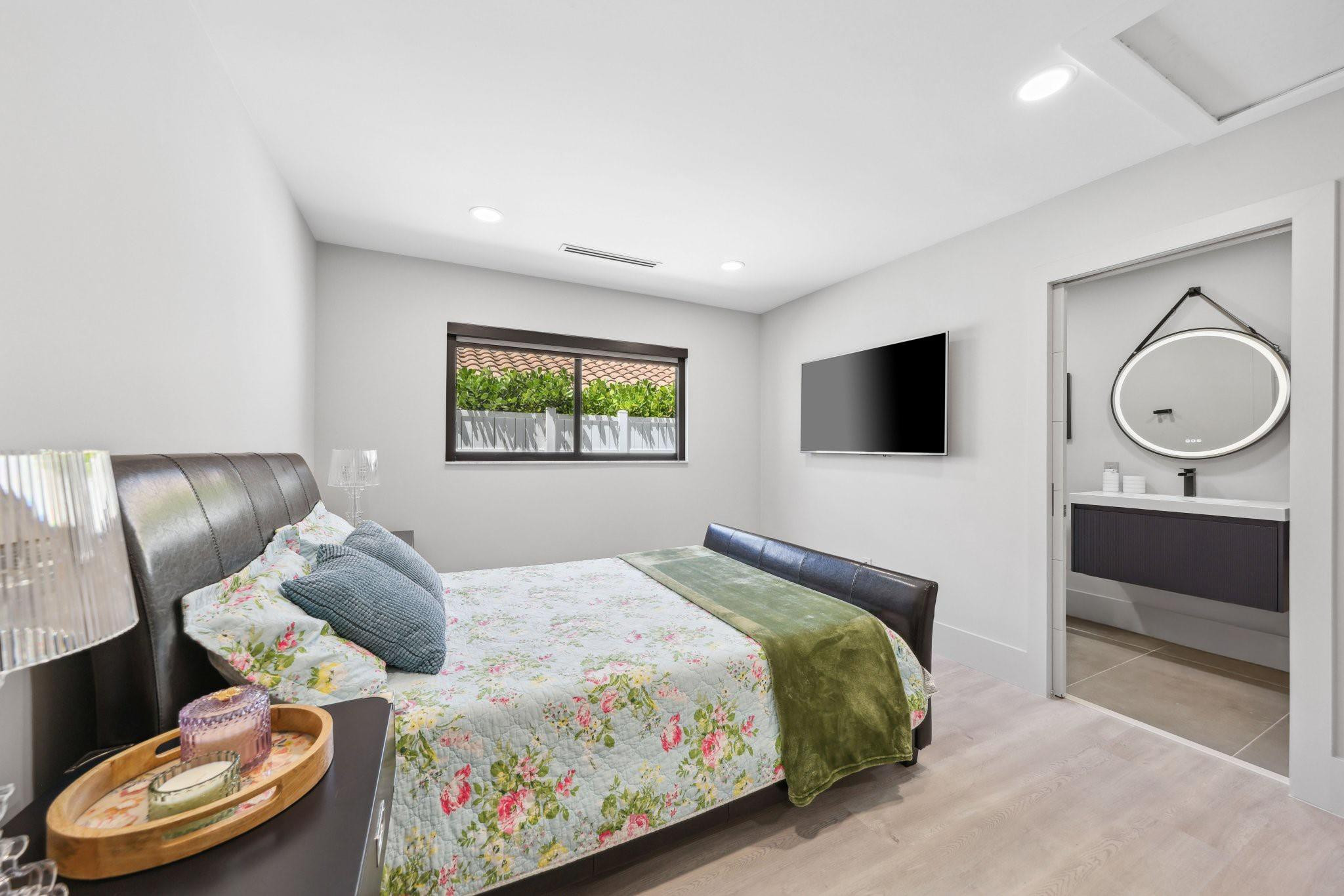 2901 Northeast 46th Street Lighthouse Point, FL 33064 - Photo 47 of 79 a bedroom with a bed and a flat screen tv