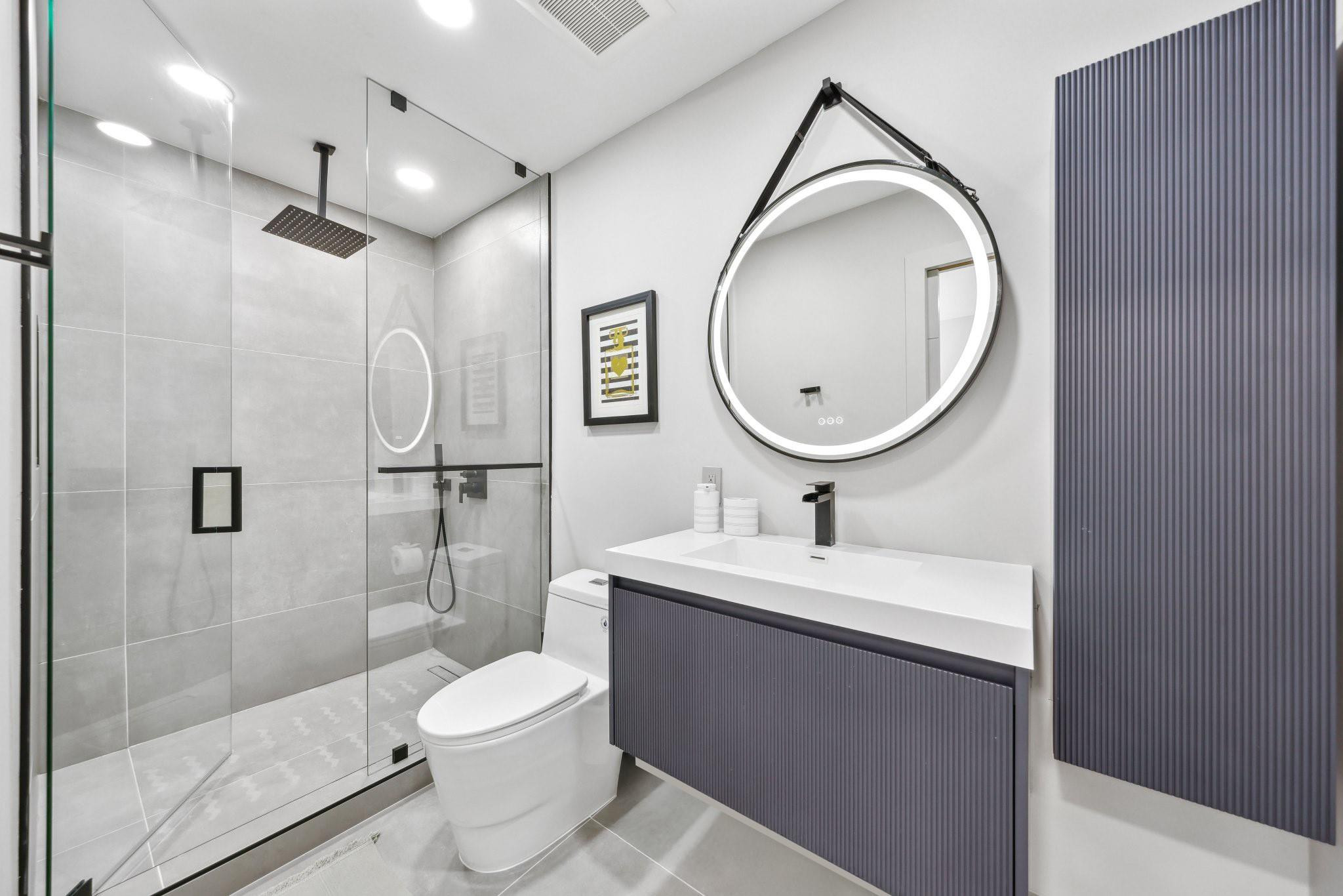 2901 Northeast 46th Street Lighthouse Point, FL 33064 - Photo 50 of 79 a bathroom with a toilet sink and a mirror