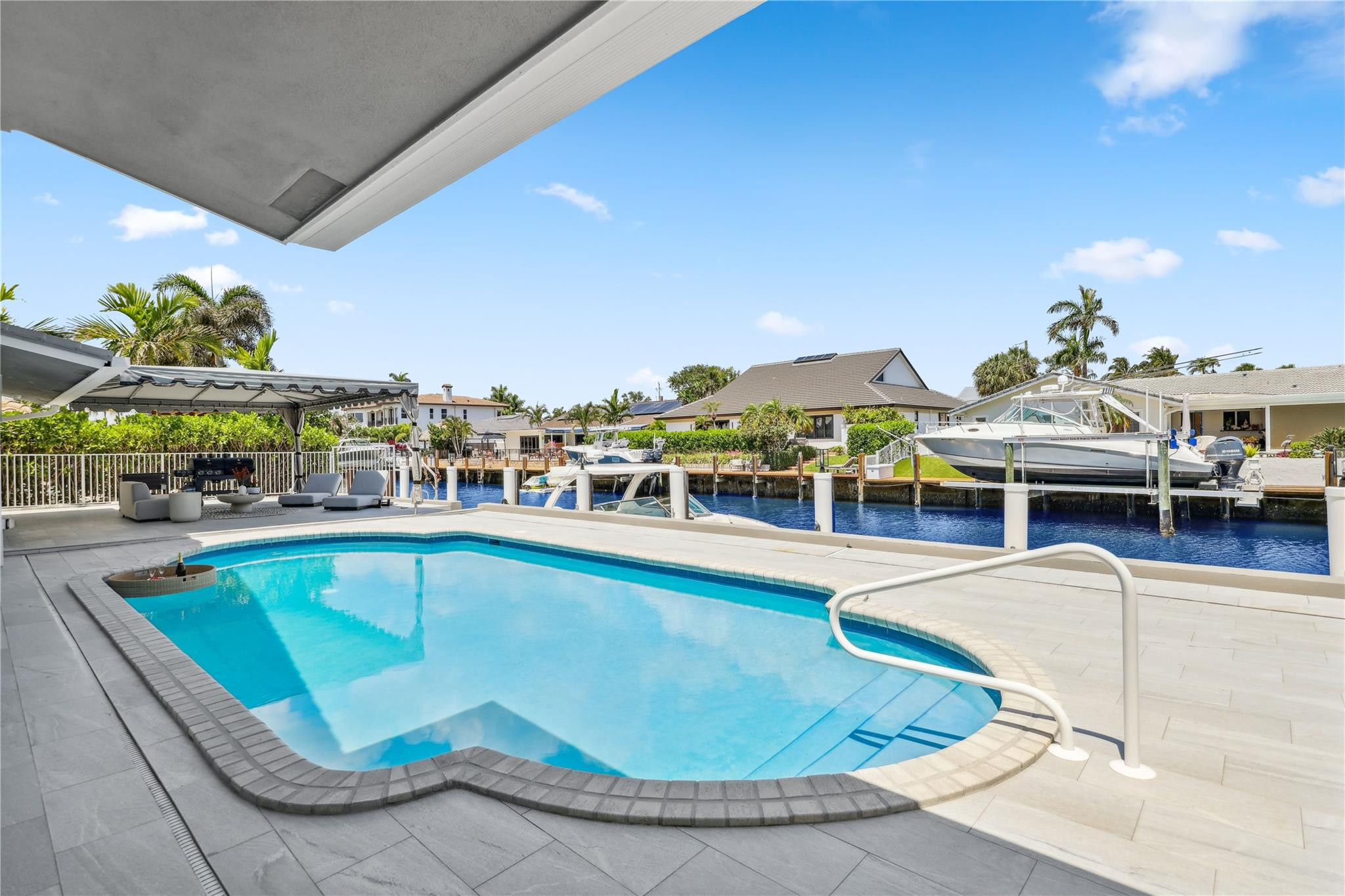 2901 Northeast 46th Street Lighthouse Point, FL 33064 - Photo 54 of 79 a view of a swimming pool with outdoor seating