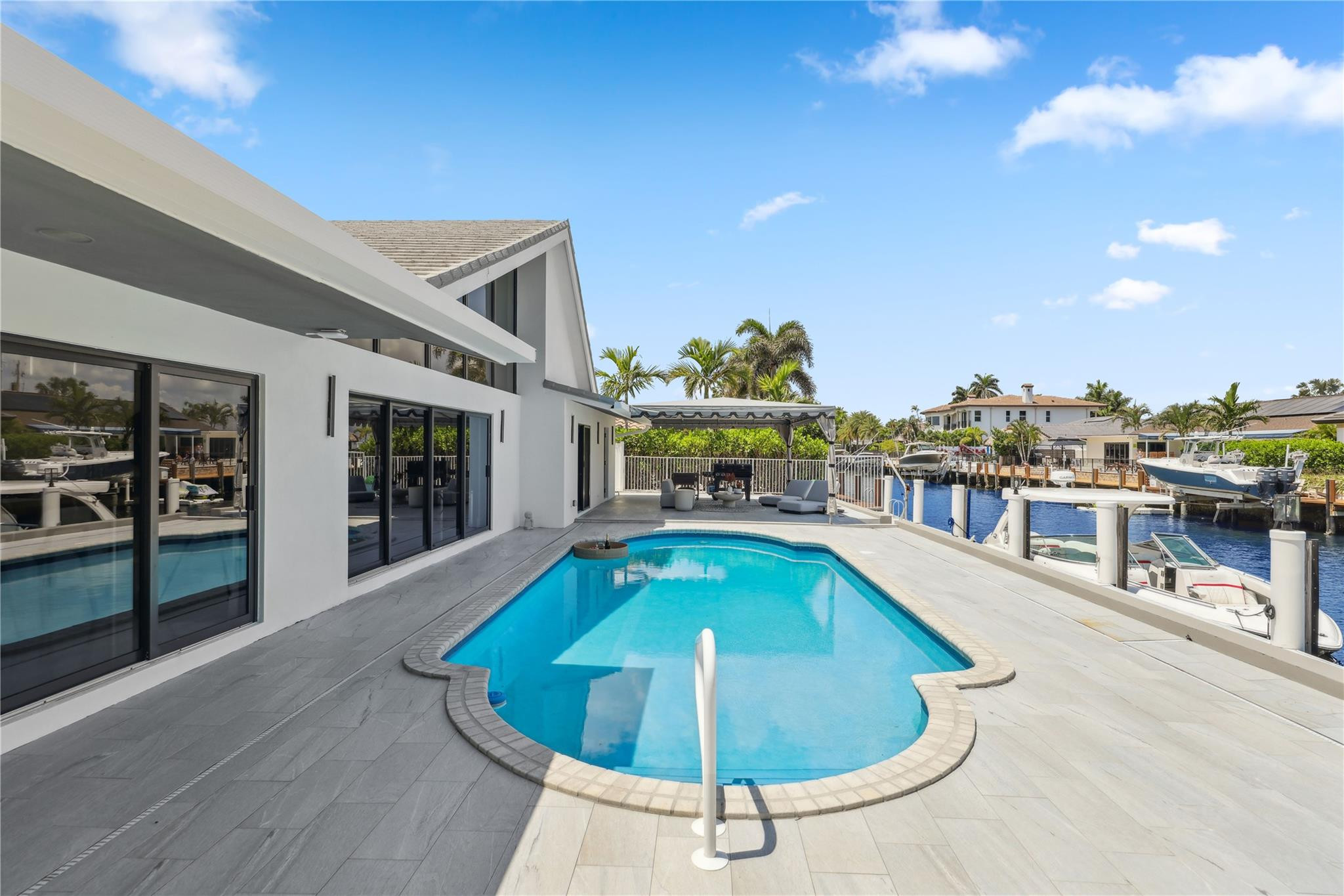 2901 Northeast 46th Street Lighthouse Point, FL 33064 - Photo 55 of 79 a view of a swimming pool with furniture