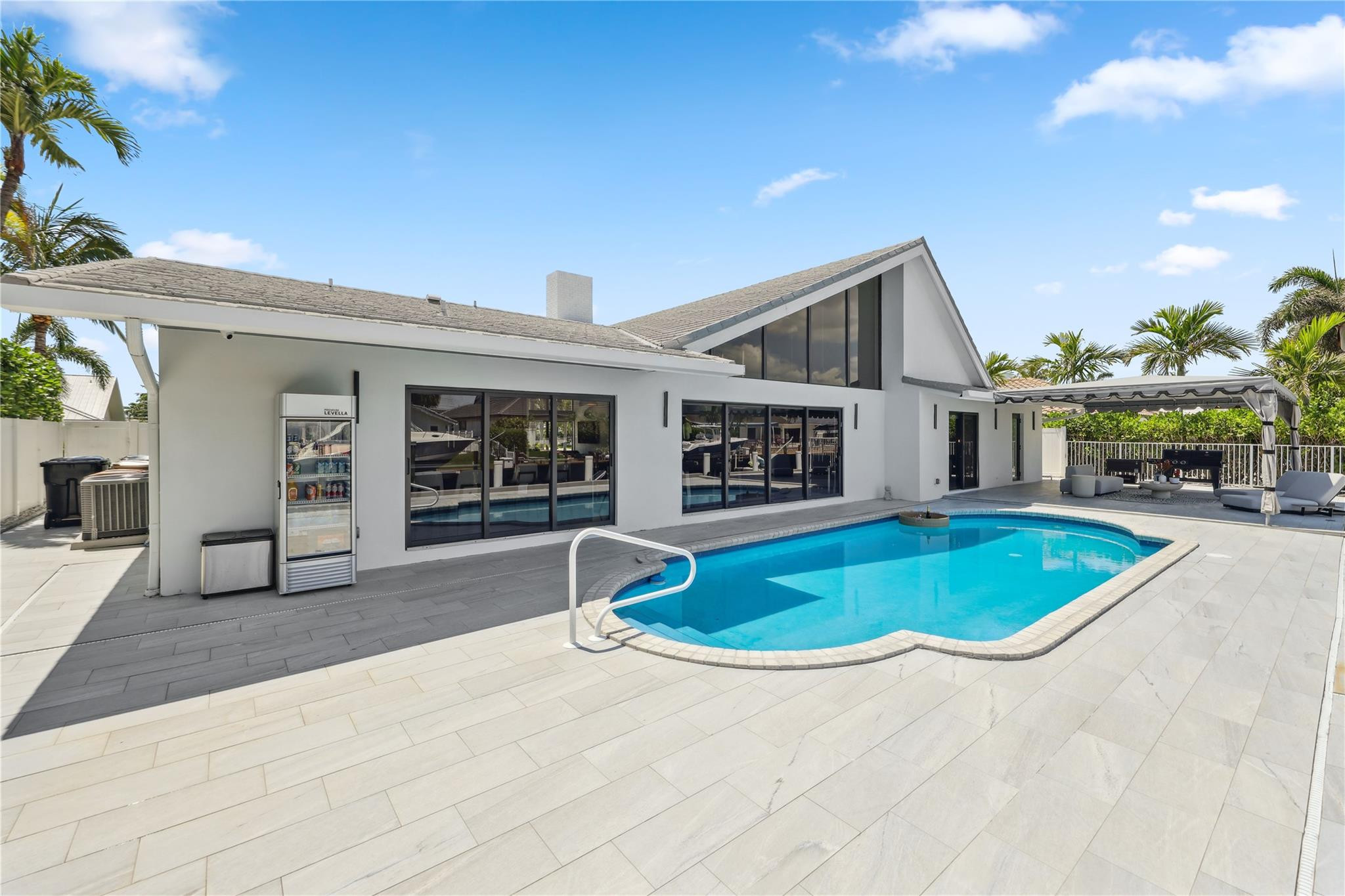 2901 Northeast 46th Street Lighthouse Point, FL 33064 - Photo 56 of 79 a front view of a house with garden space and garage