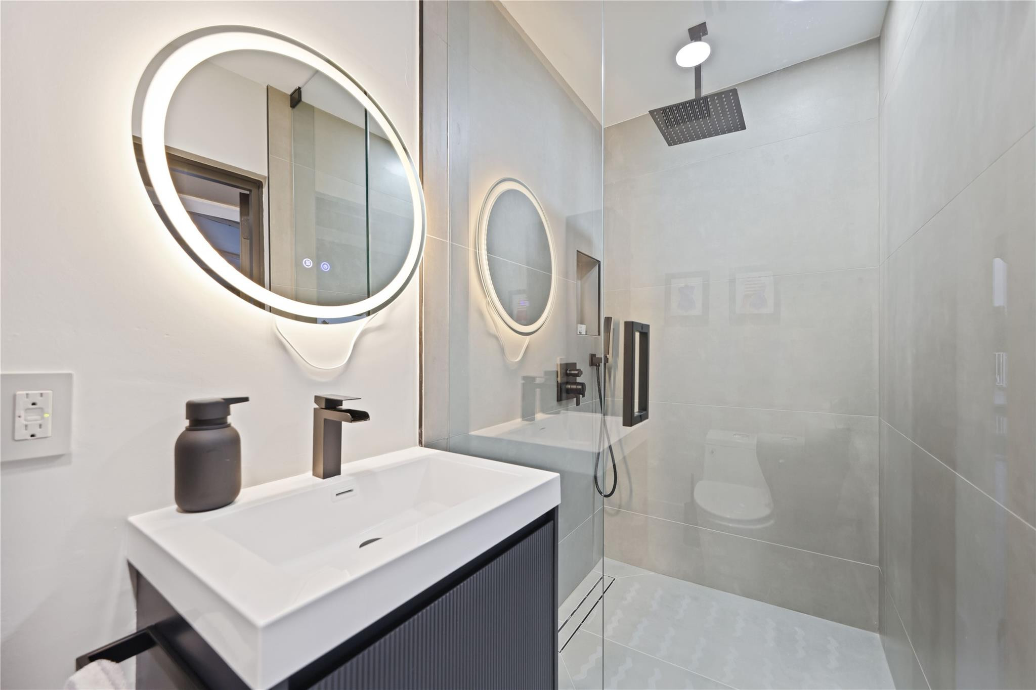 2901 Northeast 46th Street Lighthouse Point, FL 33064 - Photo 59 of 79 a bathroom with a sink a toilet and a mirror