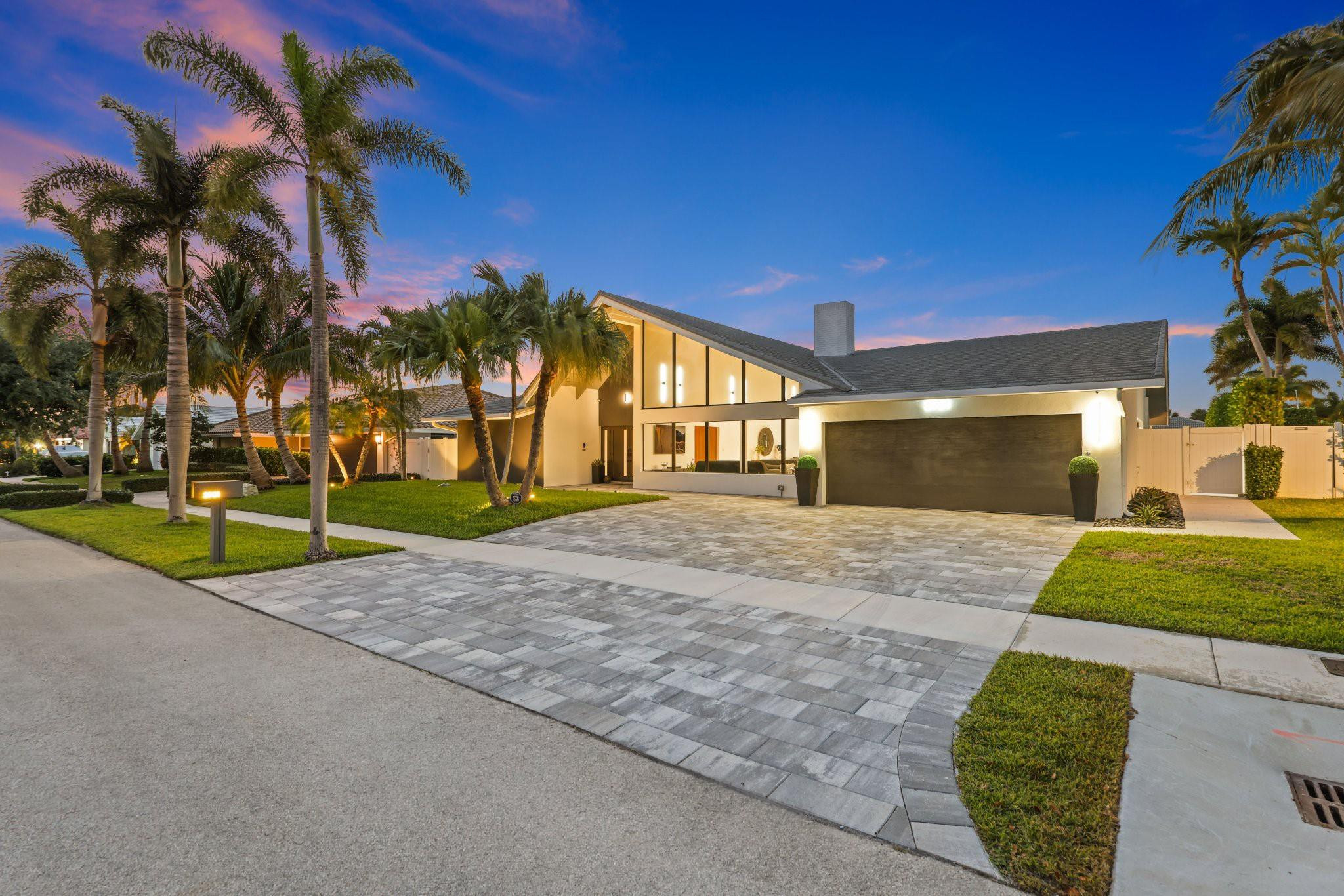 2901 Northeast 46th Street Lighthouse Point, FL 33064 - Photo 72 of 79 a front view of a house with a yard and garage