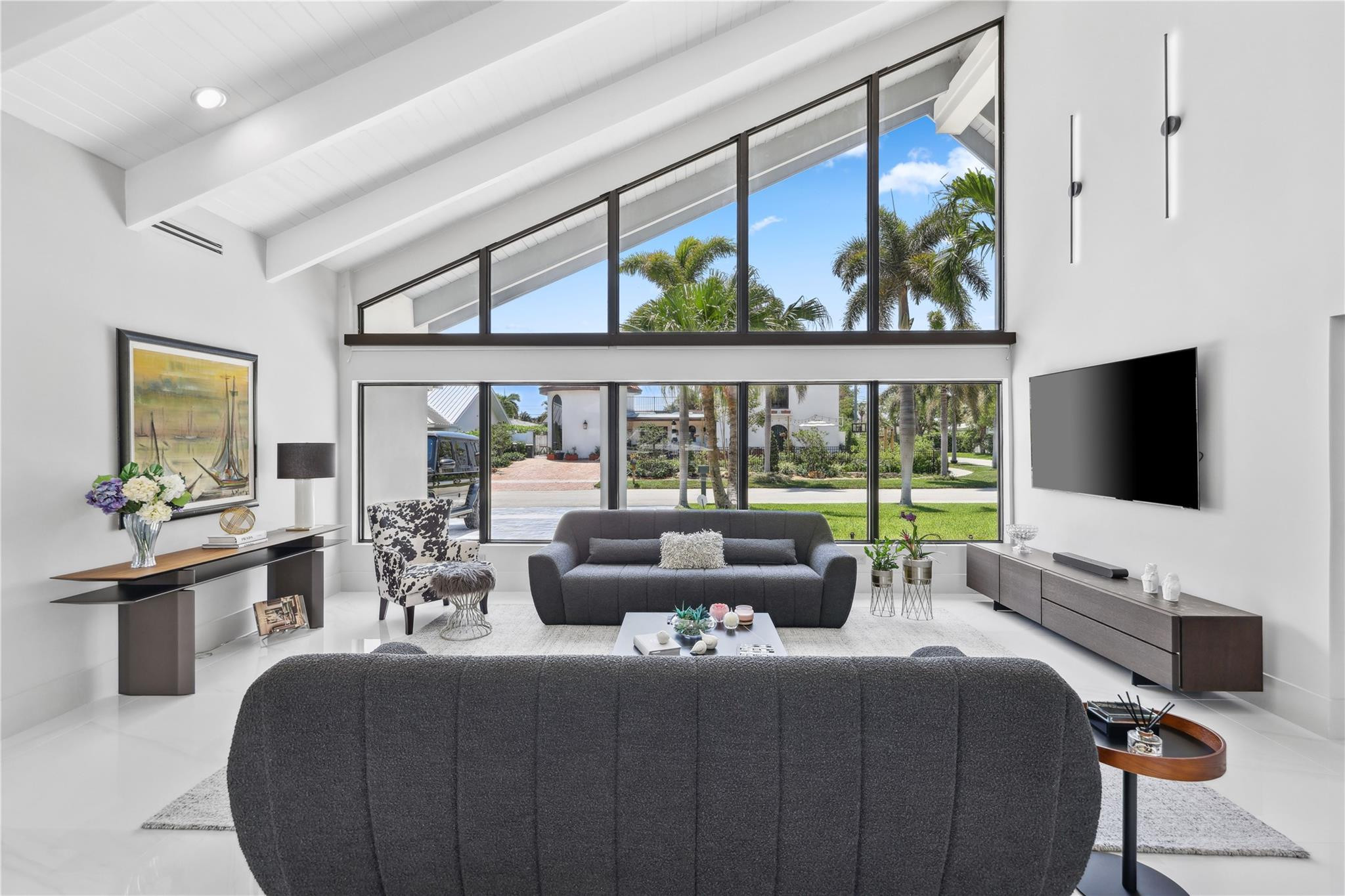 2901 Northeast 46th Street Lighthouse Point, FL 33064 - Photo 8 of 79 a living room with furniture a flat screen tv and a floor to ceiling window
