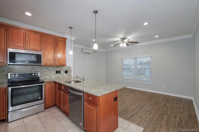 a kitchen with stainless steel appliances granite countertop a stove a sink and a microwave