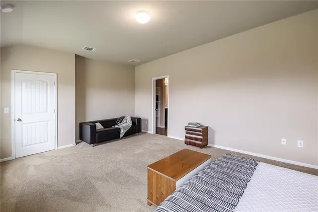 a bedroom with furniture and a wooden floor