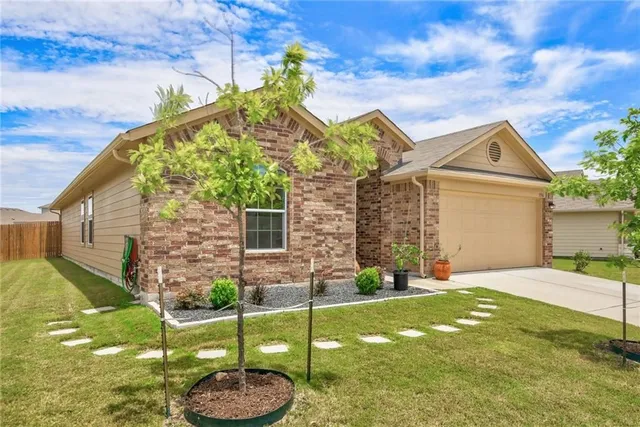 a front view of a house with a yard