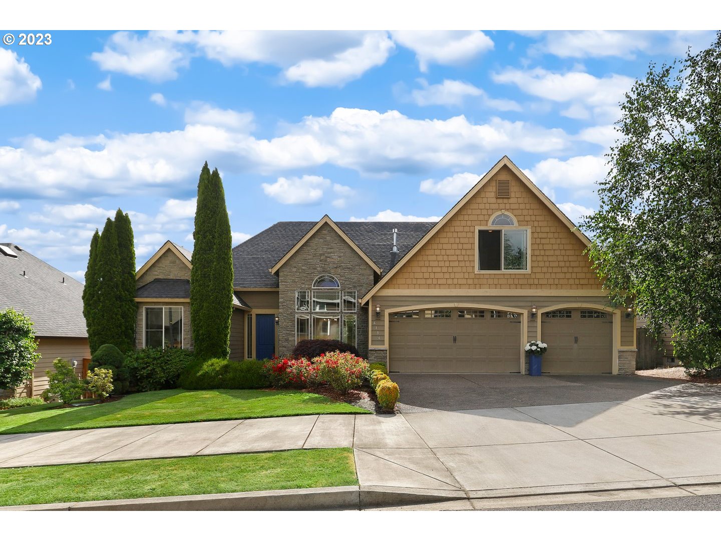 a front view of a house with a garden