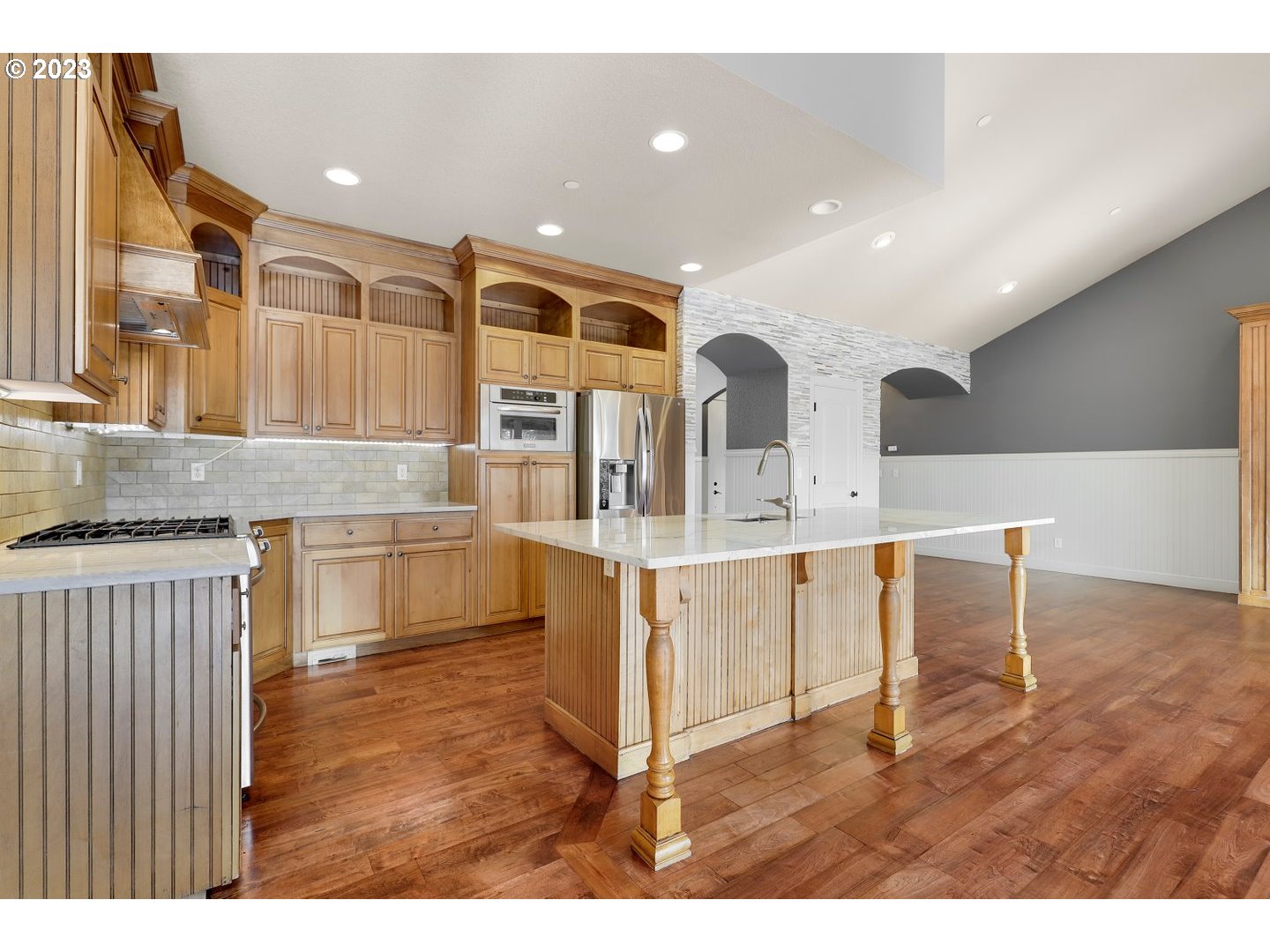 6136 Northwest Larkspur Street Camas, WA 98607 - Photo 12 of 40 a kitchen with stainless steel appliances kitchen island granite countertop a stove and a sink