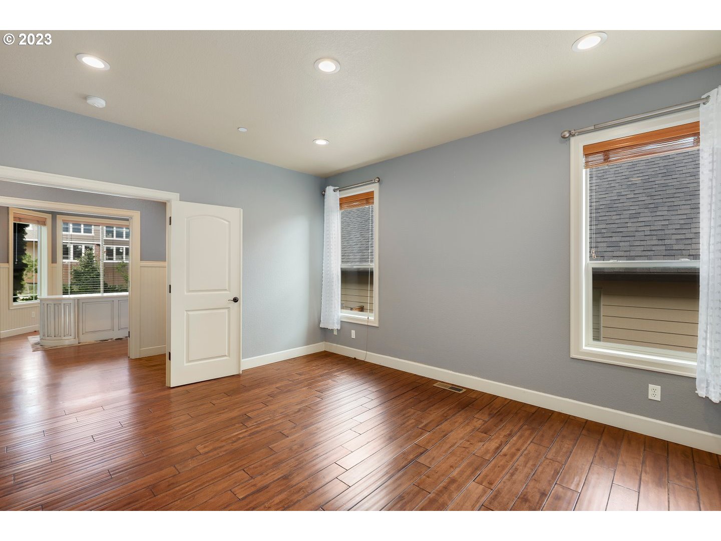 6136 Northwest Larkspur Street Camas, WA 98607 - Photo 21 of 40 a view of an empty room with wooden floor and a window
