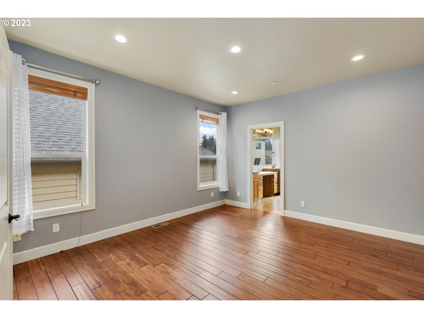 6136 Northwest Larkspur Street Camas, WA 98607 - Photo 22 of 40 a view of an empty room with wooden floor and a window