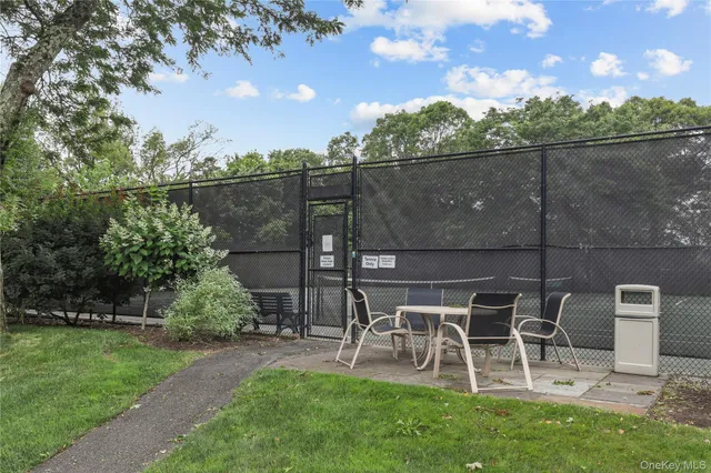 a view of a chairs and table in backyard