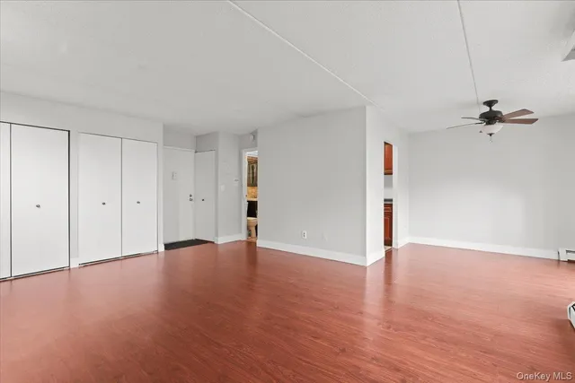 a view of an empty room with a ceiling fan
