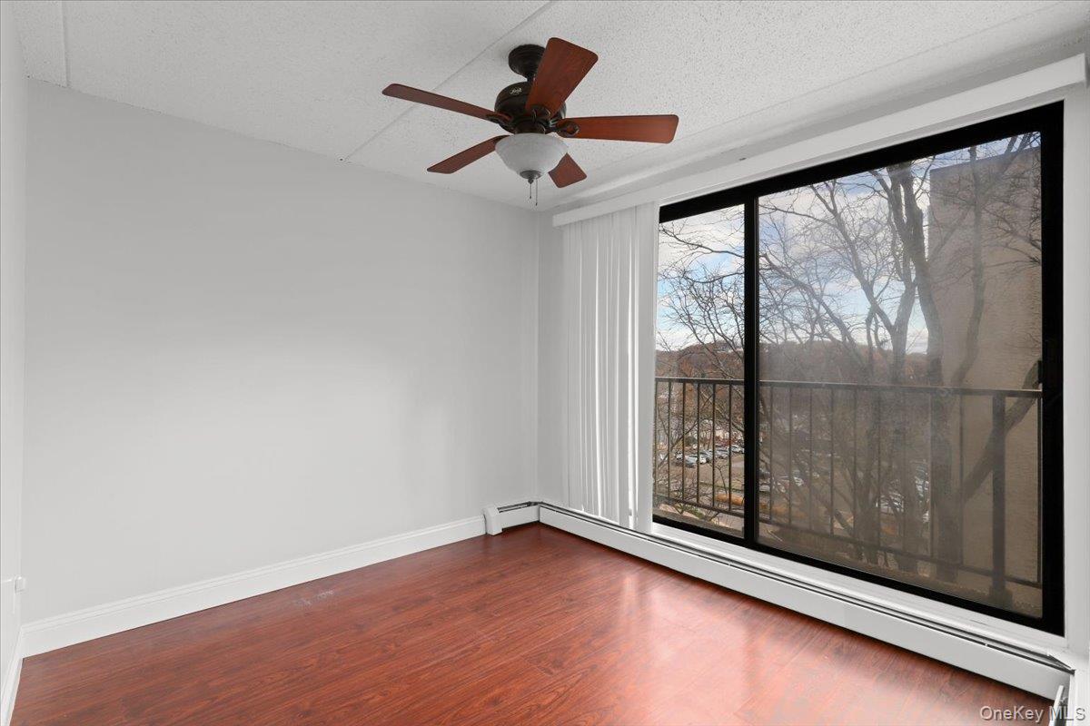 150 Overlook Avenue, Unit 6L Peekskill, NY 10566 - Photo 7 of 18 wooden floor in an empty room with a window