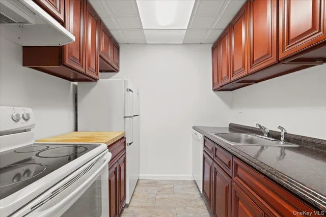 a kitchen with stainless steel appliances granite countertop a sink stove and cabinets