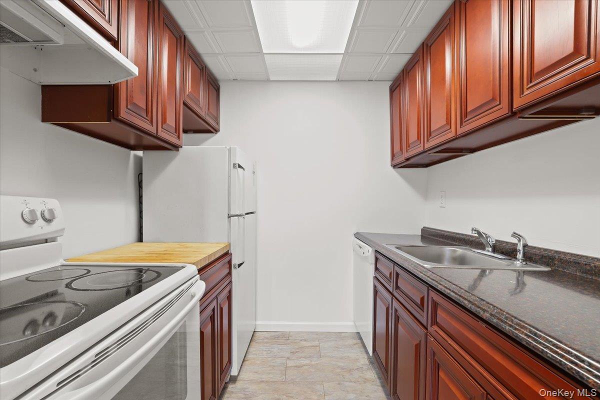 150 Overlook Avenue, Unit 6L Peekskill, NY 10566 - Photo 9 of 18 a kitchen with stainless steel appliances granite countertop a sink stove and cabinets