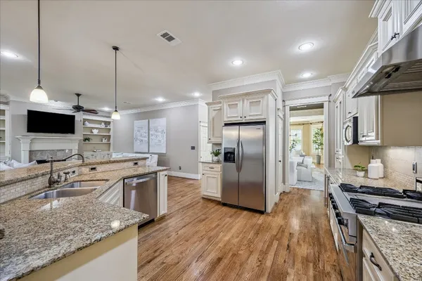 a living room with furniture a flat screen tv and a floor to ceiling window
