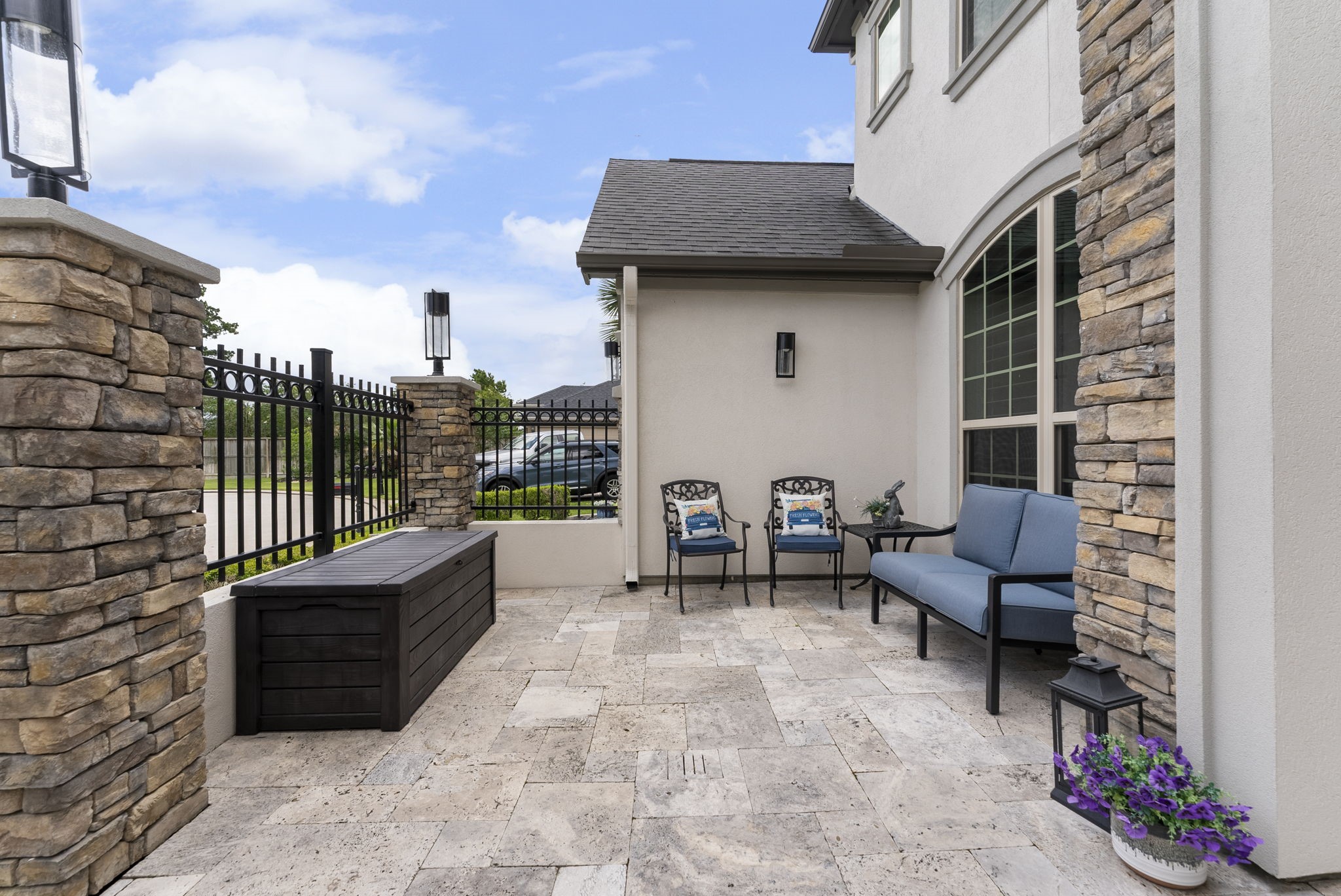 25607 Muirfield Bend Court Spring, TX 77389 - Photo 4 of 30 Inviting outdoor courtyard showcasing natural stone flooring, sophisticated architectural elements, and a tranquil ambiance ideal for everyday enjoyment.