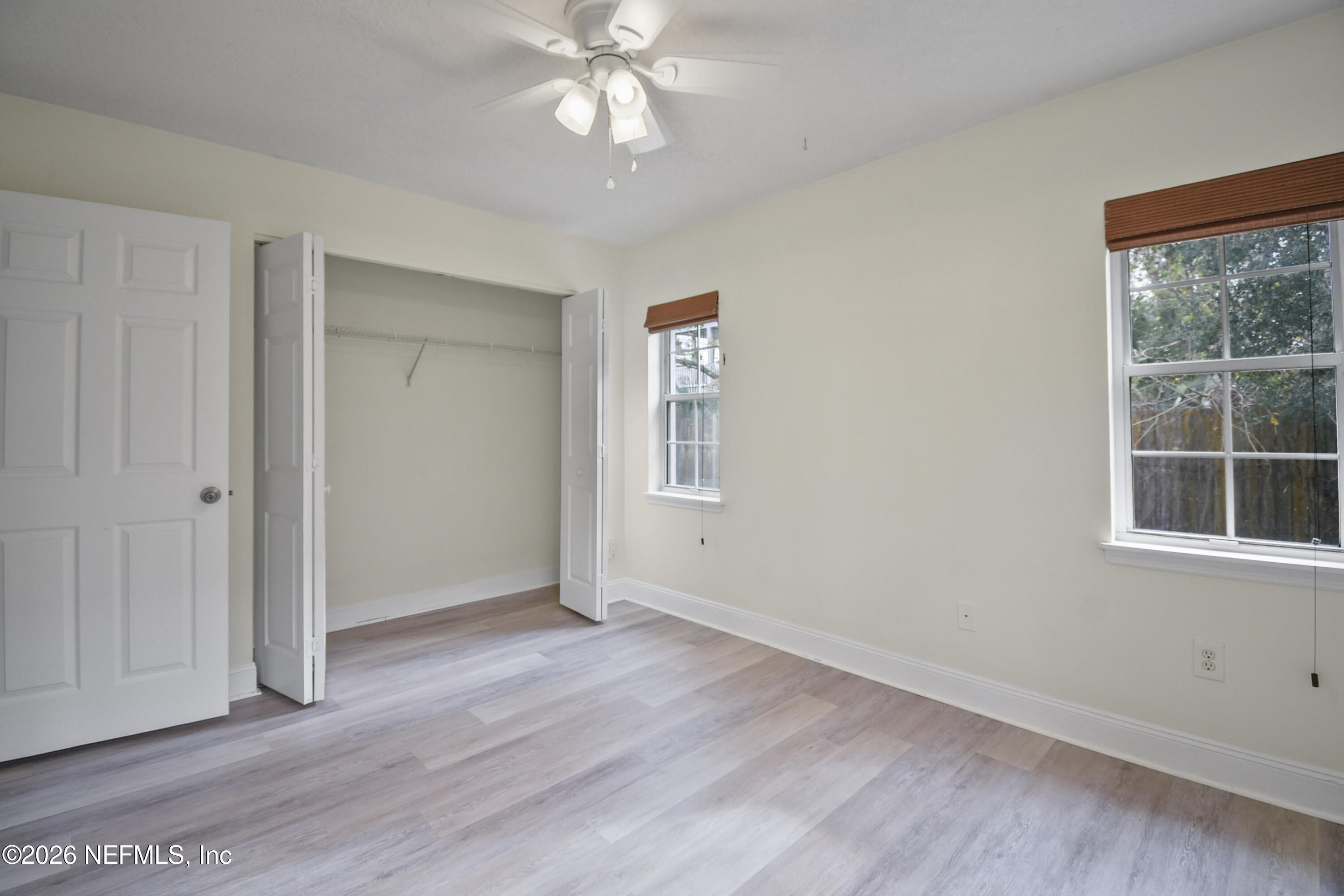 303 D Street St. Augustine Beach, FL 32080 - Photo 19 of 39 a view of an empty room with a window and wooden floor