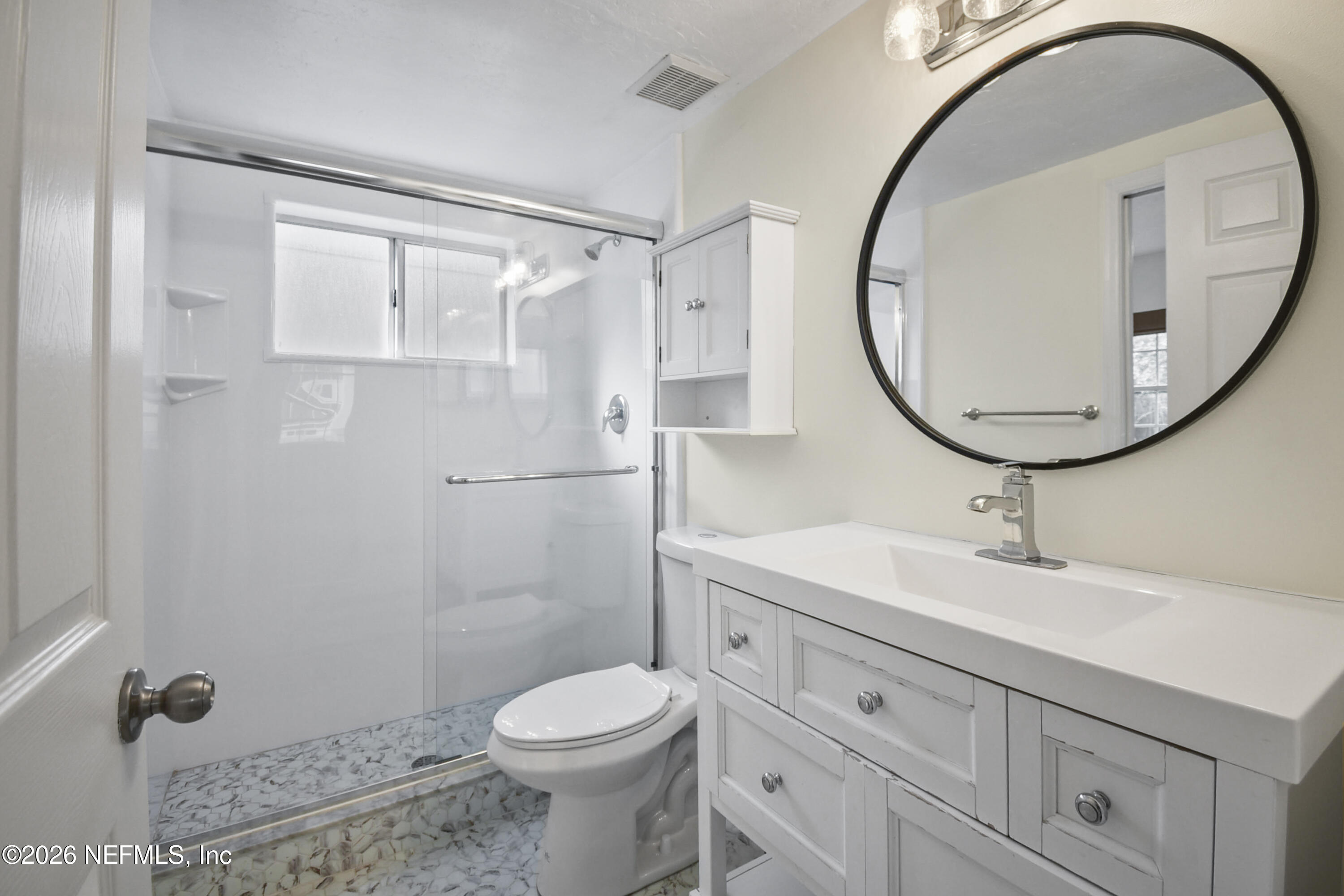 303 D Street St. Augustine Beach, FL 32080 - Photo 21 of 39 a bathroom with a sink a toilet and a mirror