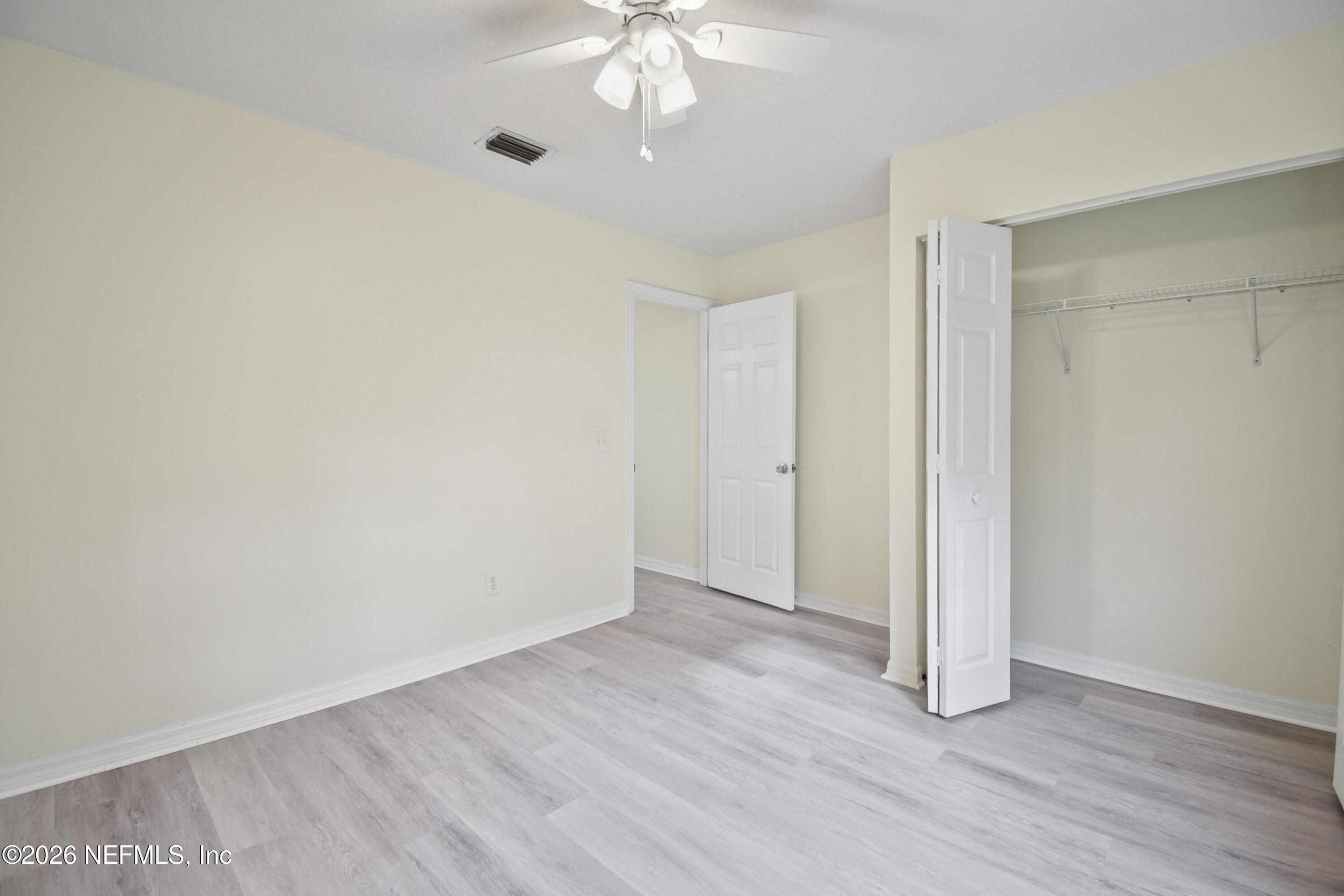303 D Street St. Augustine Beach, FL 32080 - Photo 25 of 39 a view of an empty room with wooden floor