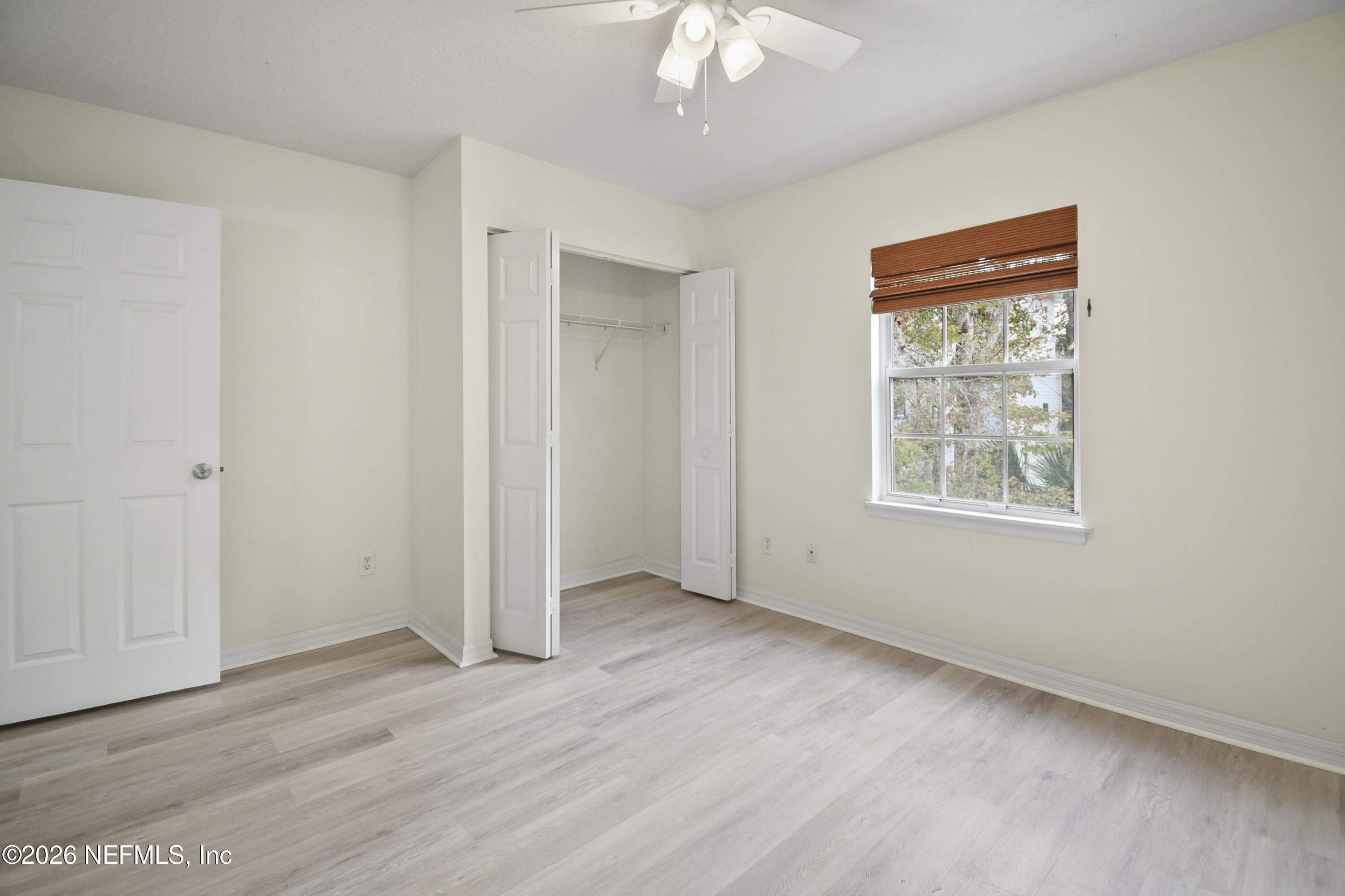 303 D Street St. Augustine Beach, FL 32080 - Photo 26 of 39 an empty room with wooden floor and windows