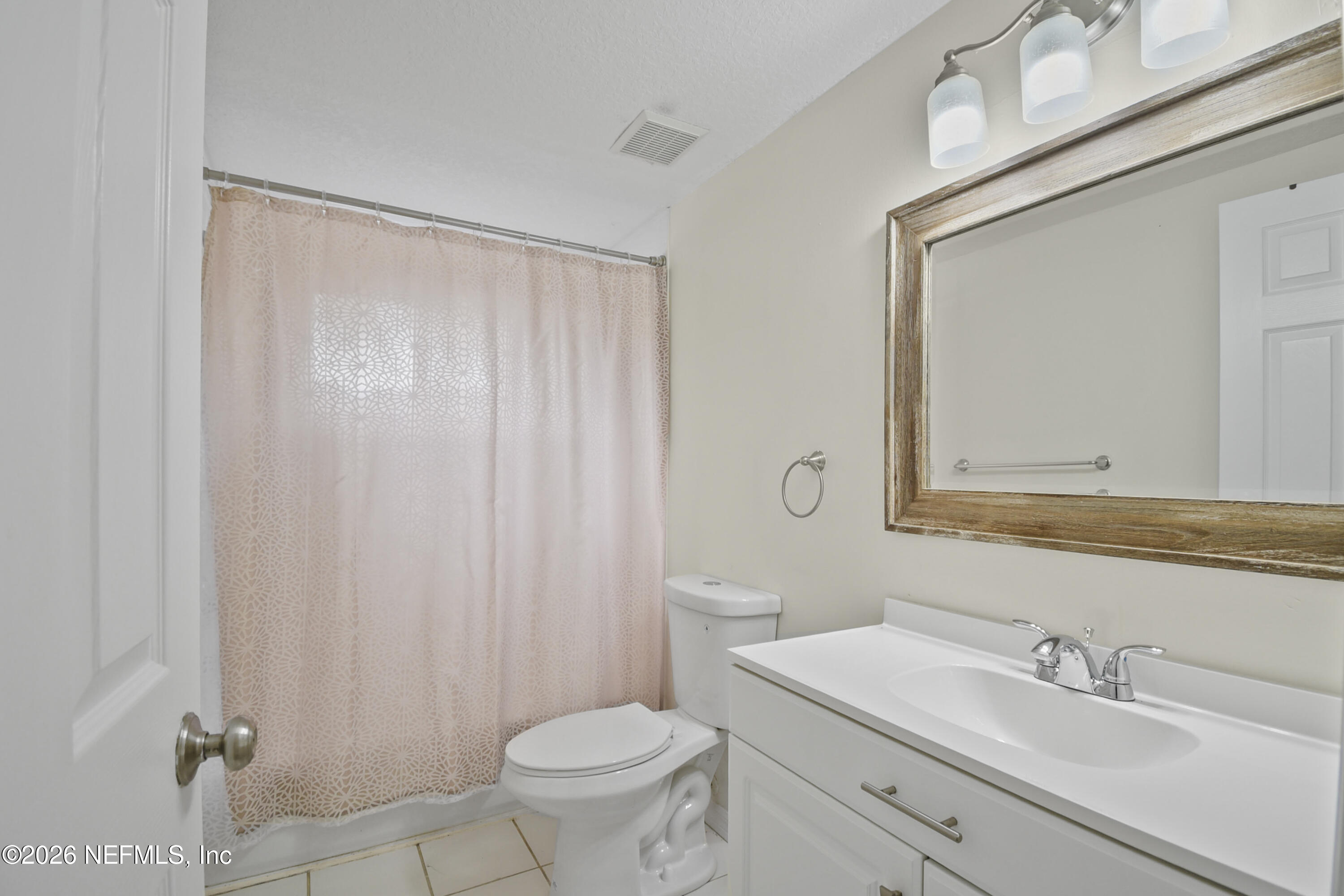 303 D Street St. Augustine Beach, FL 32080 - Photo 27 of 39 a bathroom with a sink a toilet and a mirror