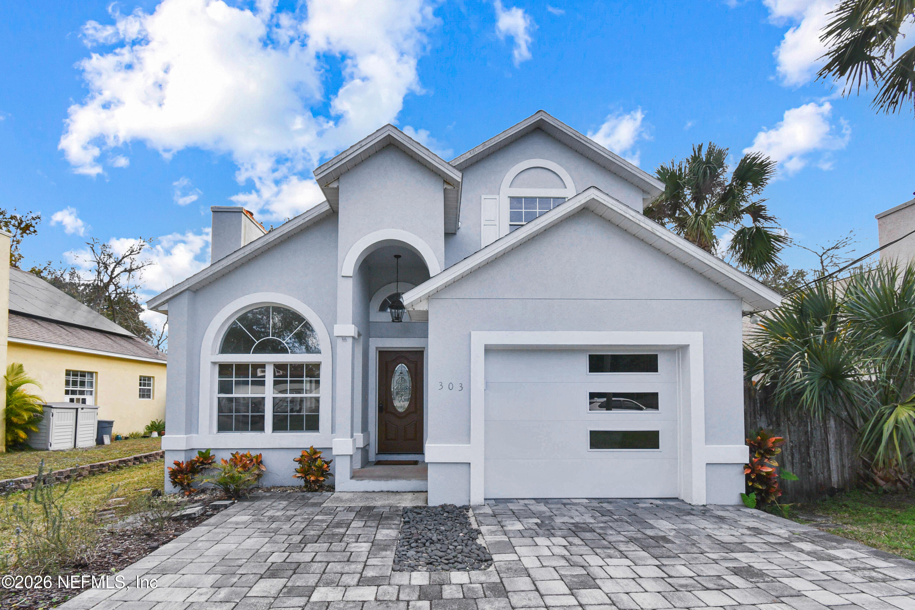 303 D Street St. Augustine Beach, FL 32080 - Photo 3 of 39 a front view of a house with garden