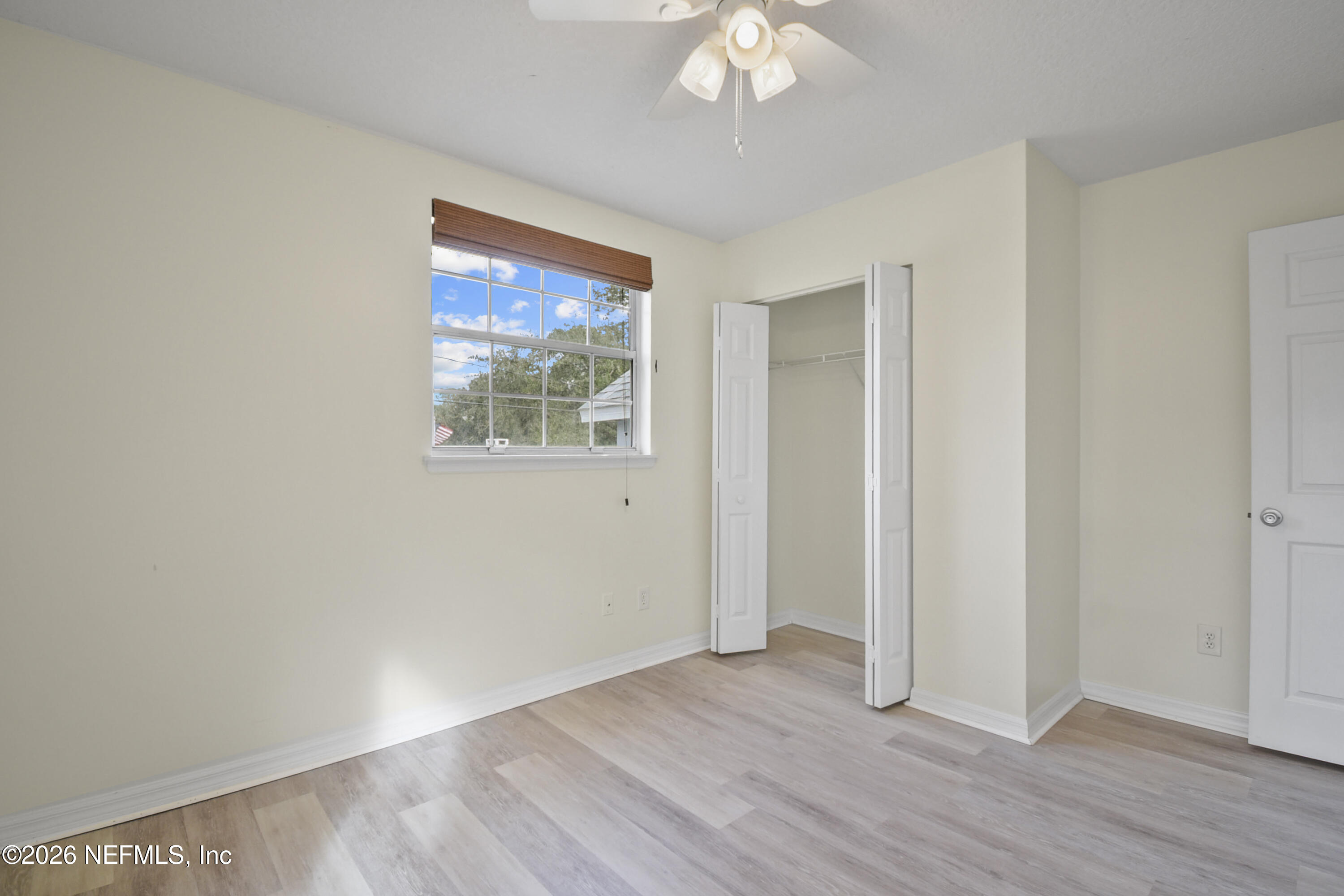 303 D Street St. Augustine Beach, FL 32080 - Photo 31 of 39 a view of an empty room with wooden floor and a window