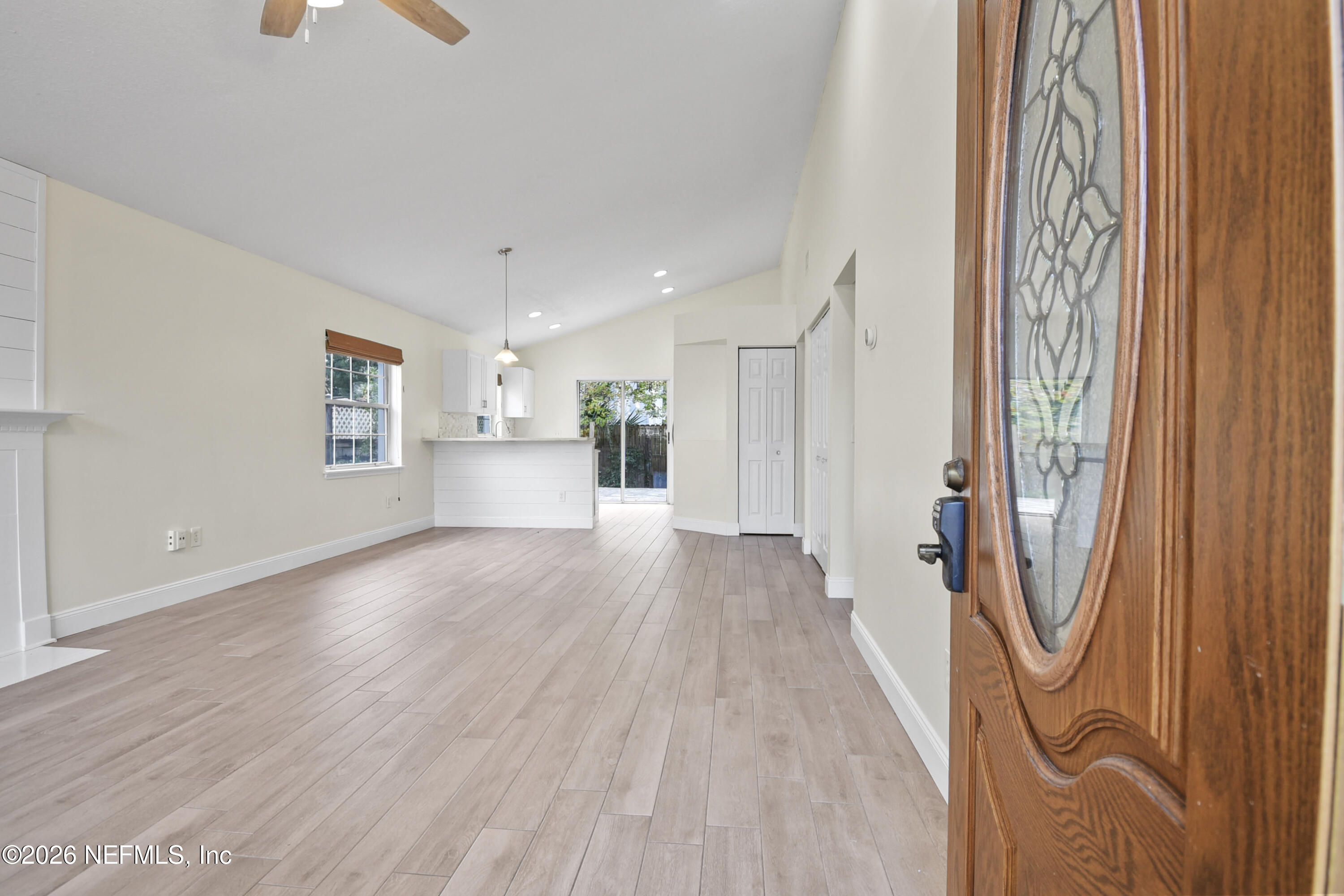 303 D Street St. Augustine Beach, FL 32080 - Photo 5 of 39 a view of a big room with wooden floor and windows